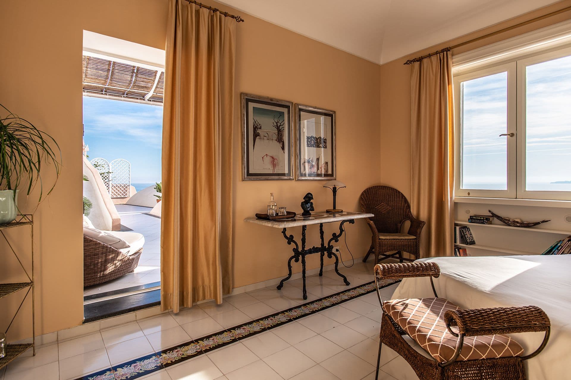 Bedroom opening directly onto a private terrace with sea views