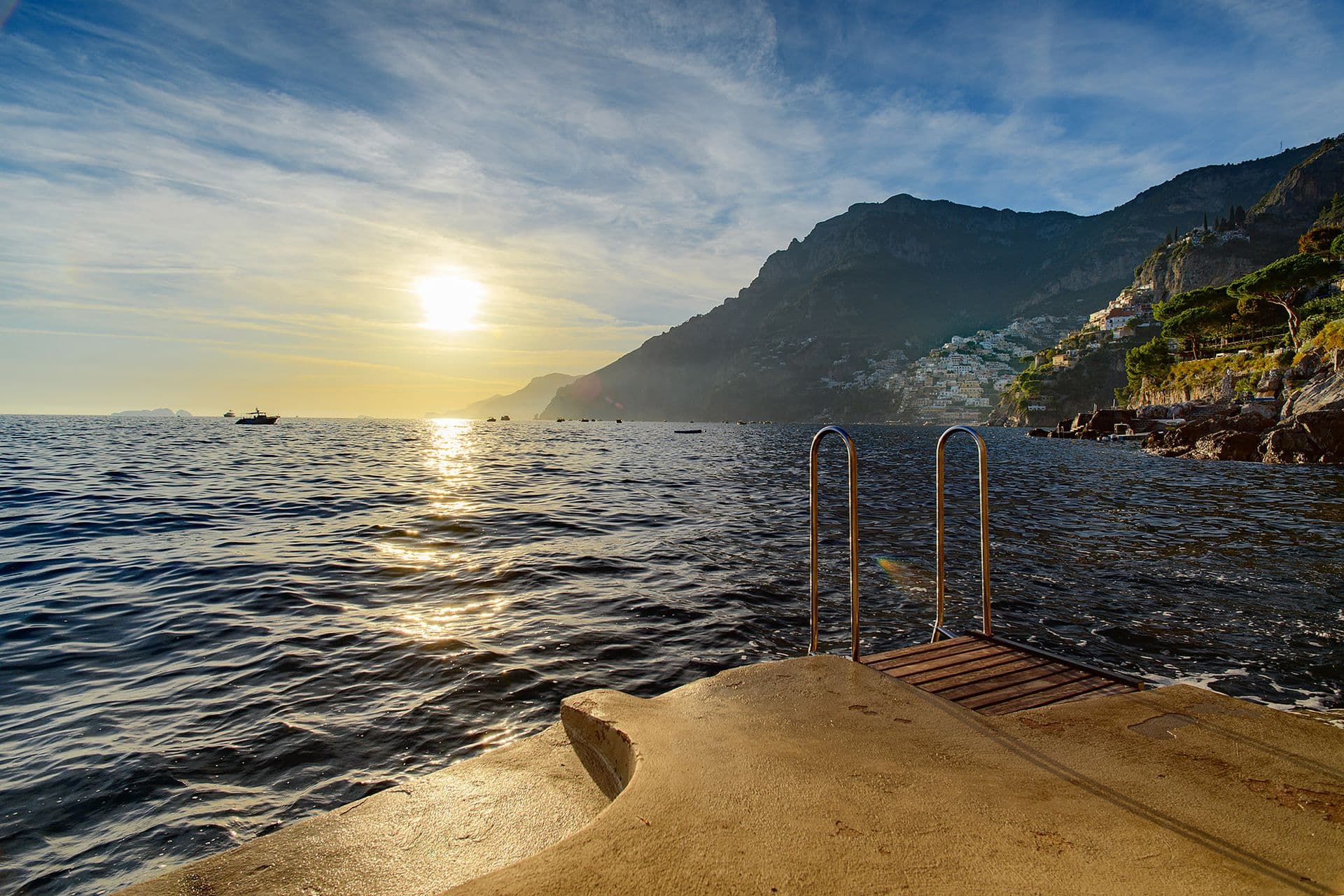 Sunset over the sea from the property's private steps into the water