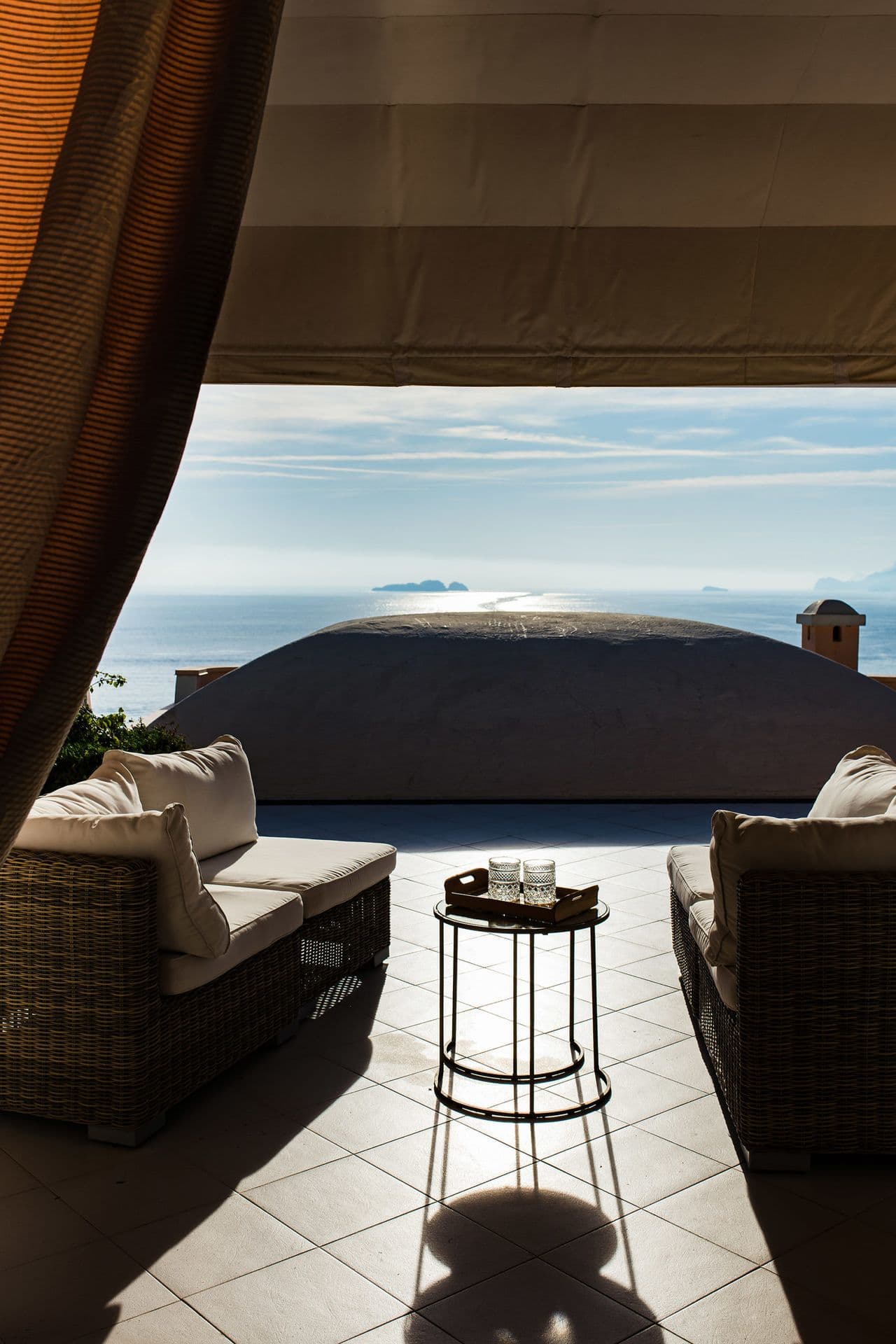 Shaded terrace lounge overlooking the sea