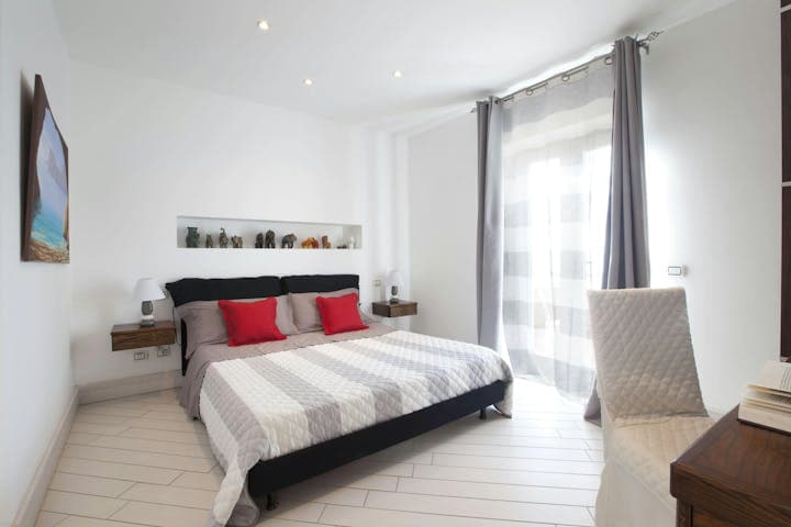 The Italian Pearl master bedroom with king-size bed and contemporary design, Sorrento, Italy