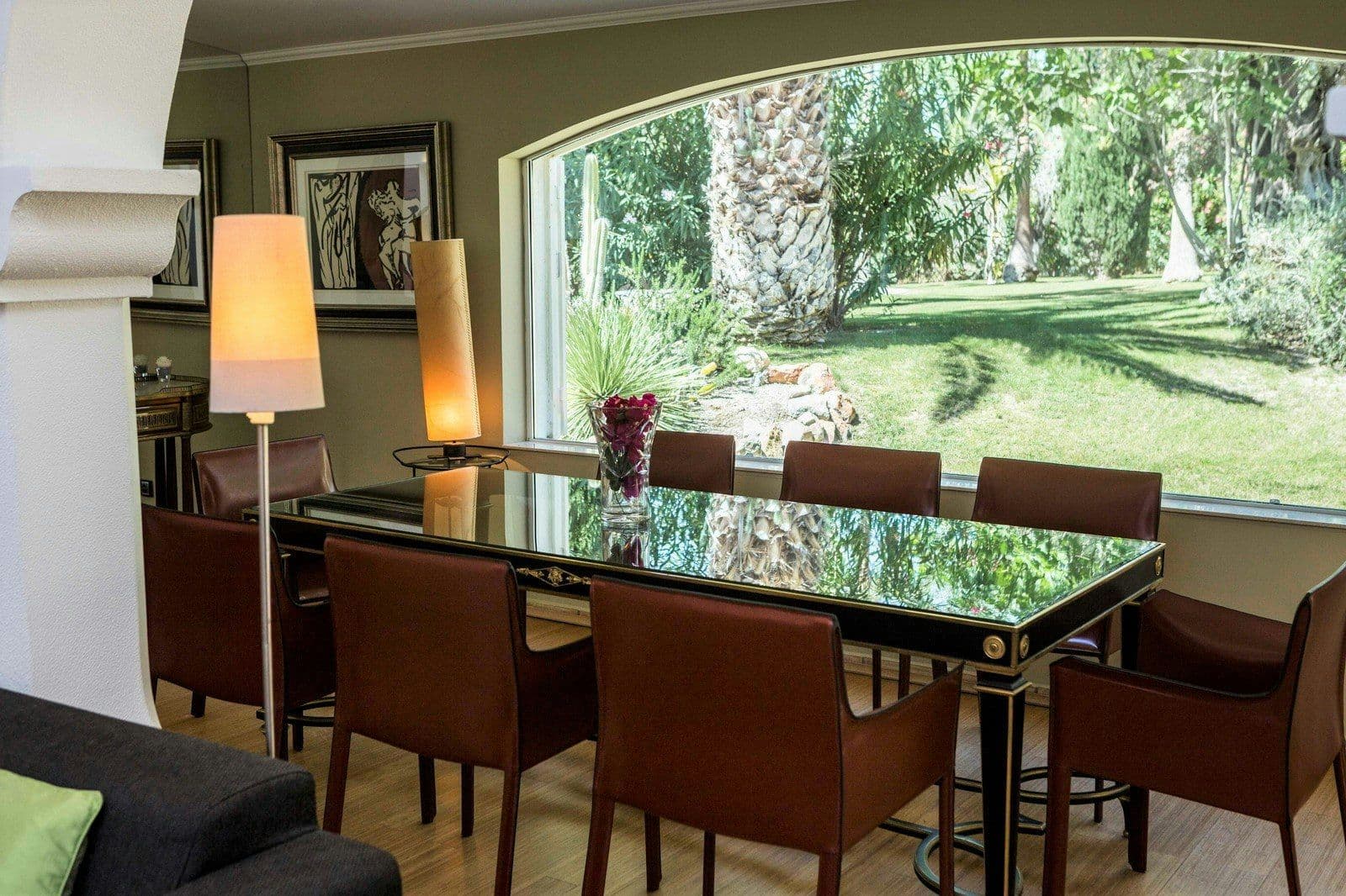 Indoor dining room with a glass table and garden view at Your Algarve Oasis
