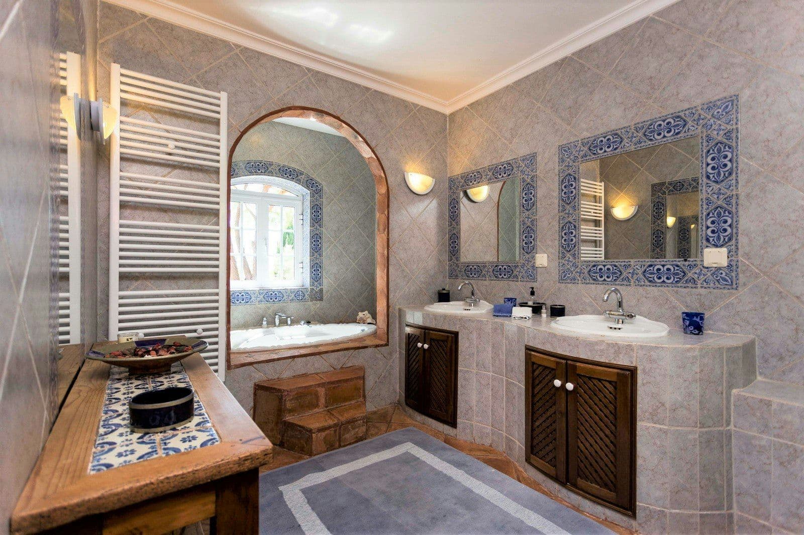 En-suite bathroom with twin basins and tiled detailing at Your Algarve Oasis