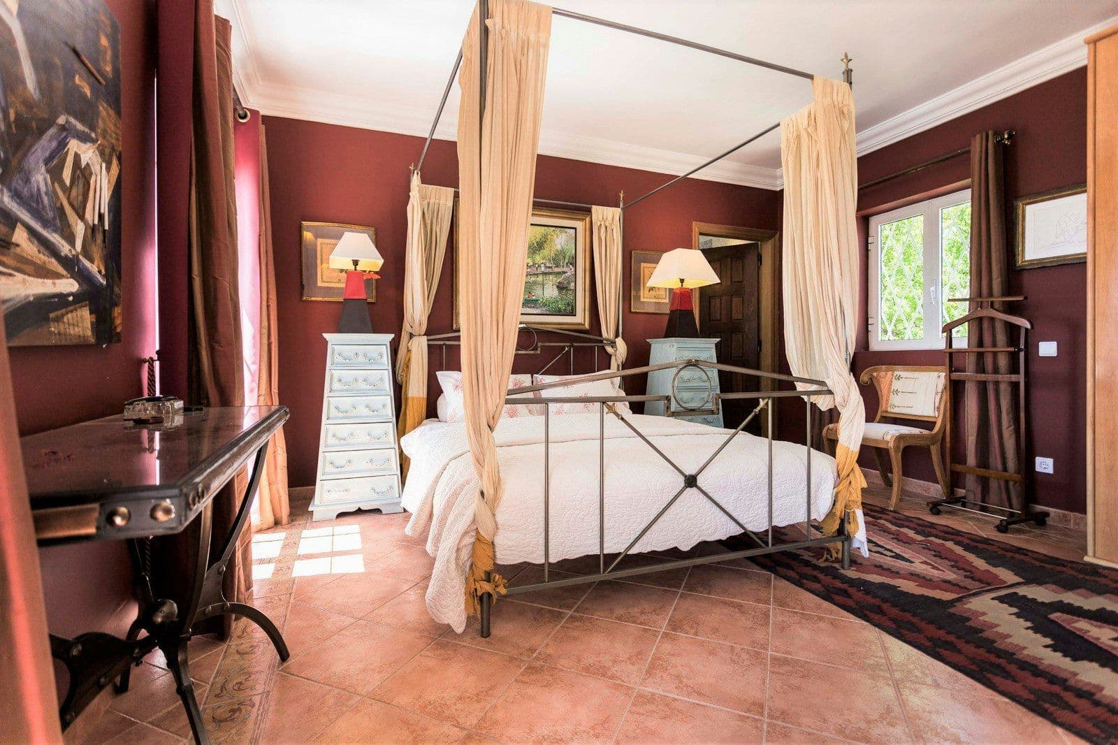 Bedroom with a four-poster bed in deep red at Your Algarve Oasis