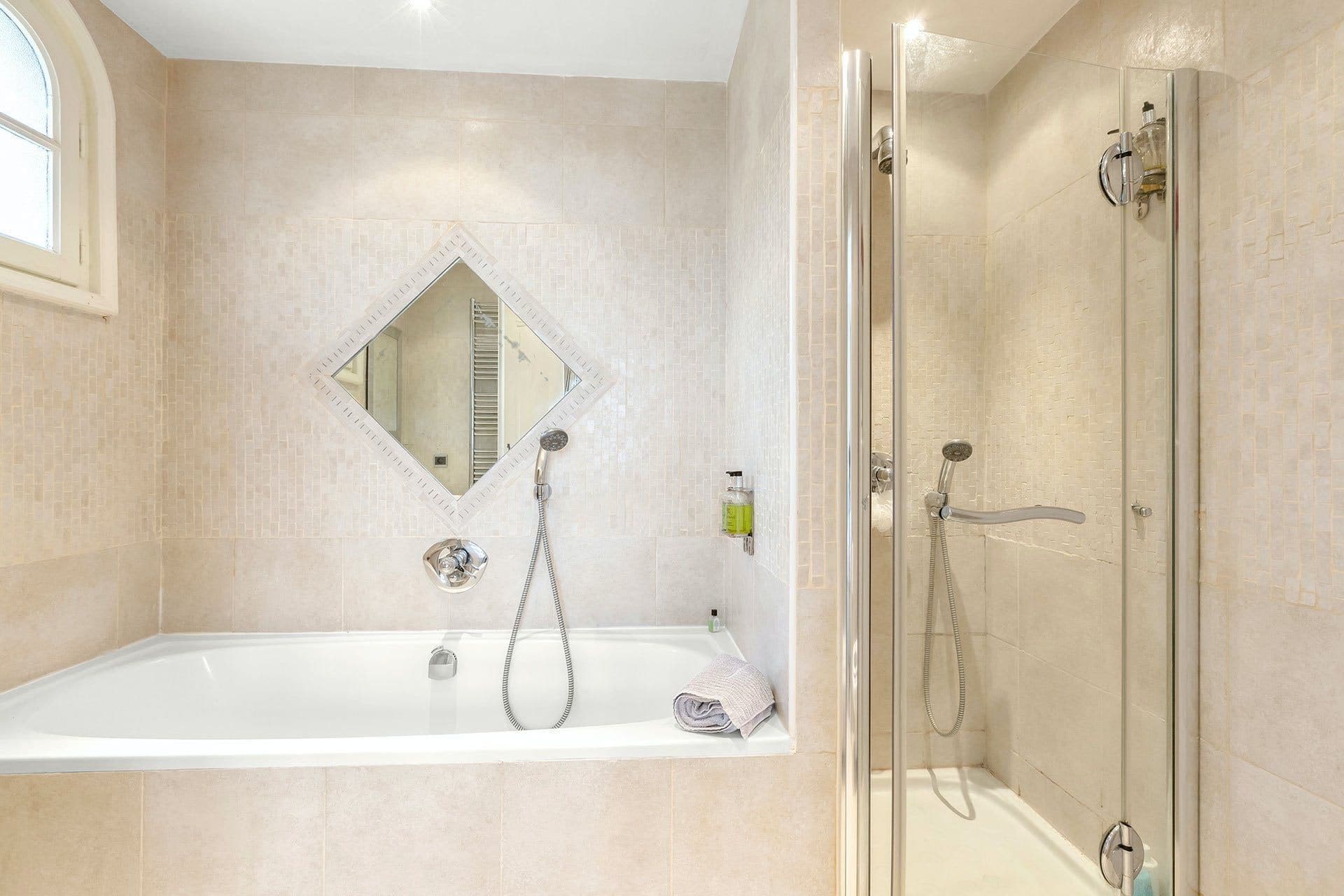 Ensuite bathroom with corner bathtub and separate walk-in shower