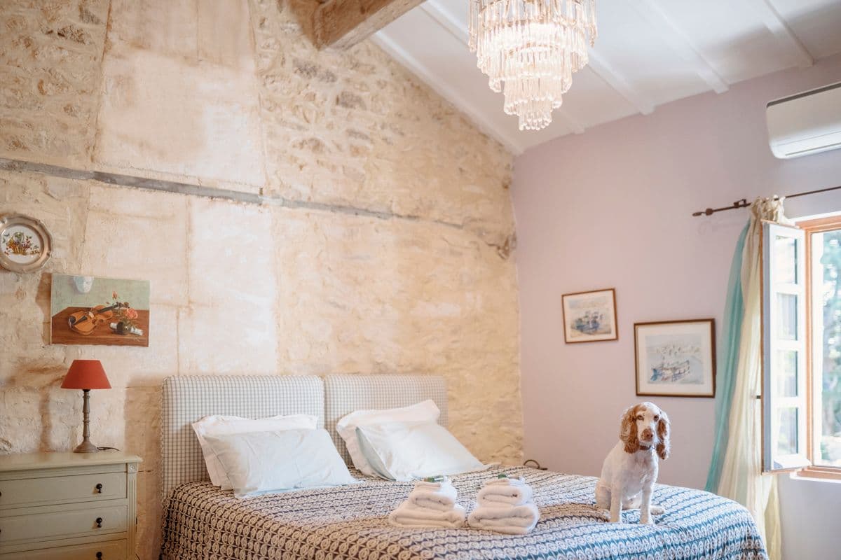 Double bedroom with cream walls and dressed bed