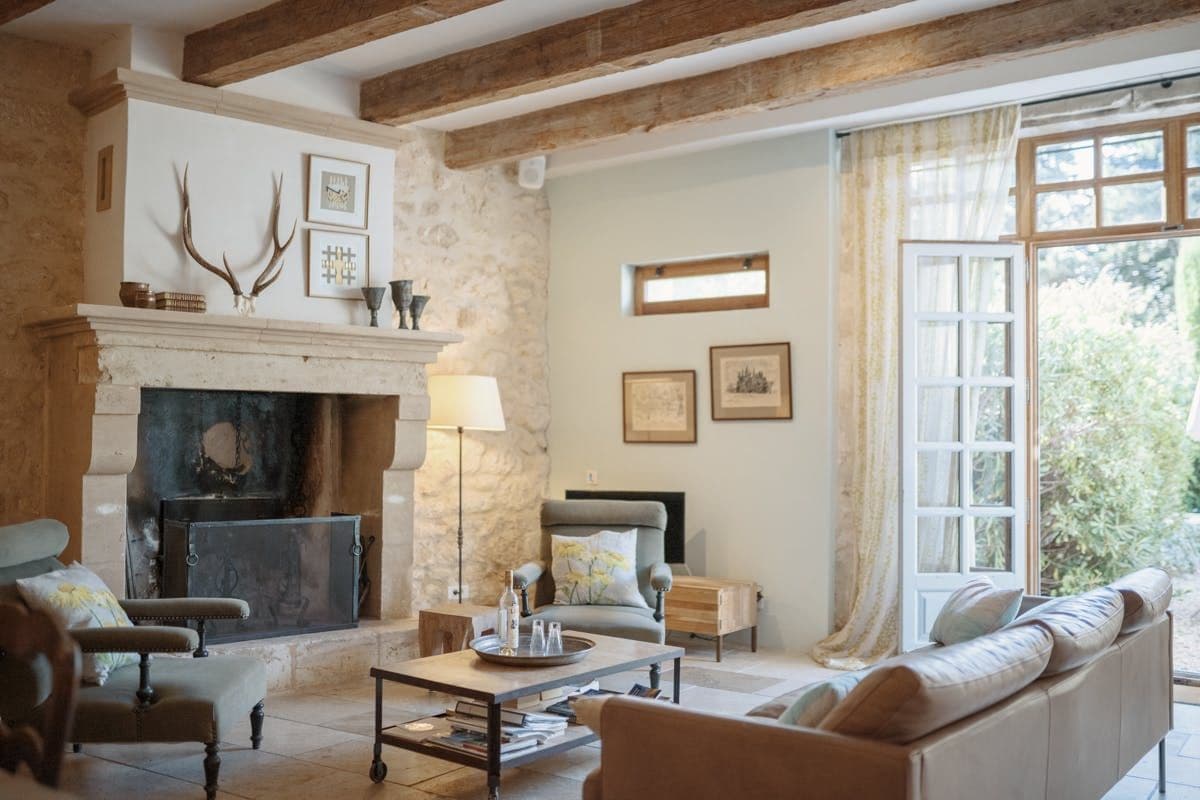 Beamed living room with stone fireplace and antler decor