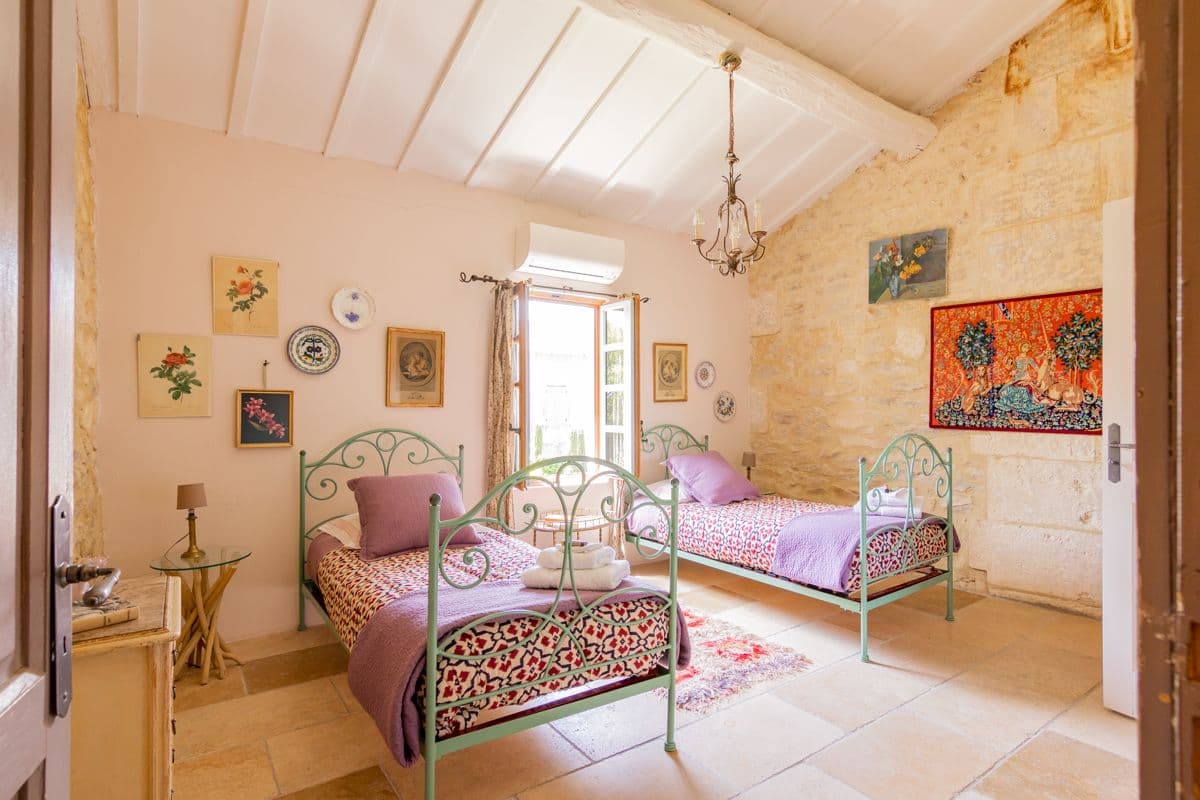 Guest bedroom with purple velvet curtain and stone walls