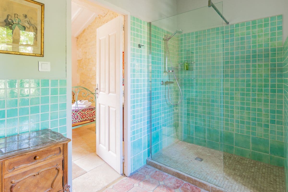 Bathroom with turquoise tiled walk-in shower