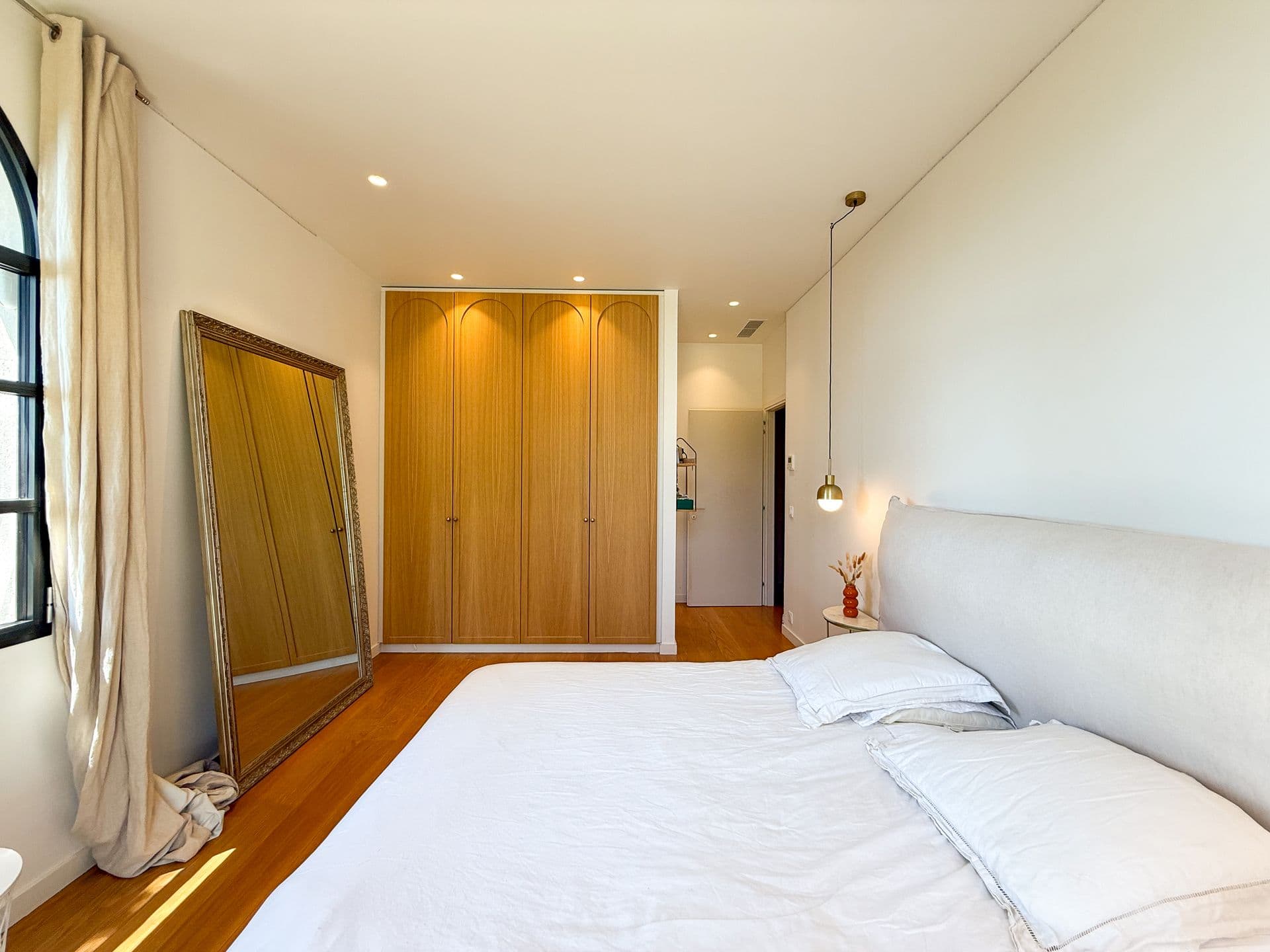 Double bedroom with fitted oak wardrobes and a full-length mirror at An Azure Vision, Cannes