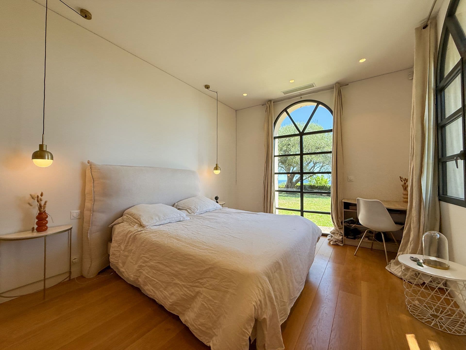 Double bedroom with arched windows onto the garden at An Azure Vision, Cannes