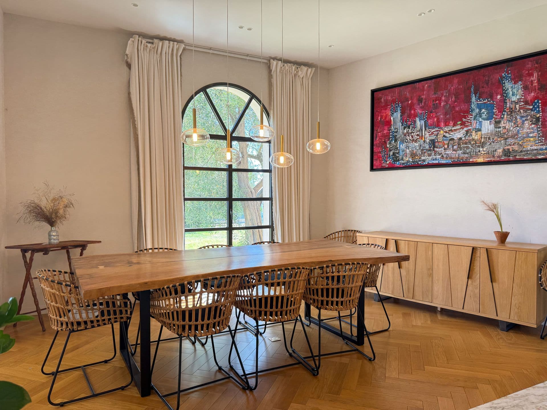 Breakfast room with rattan chairs, an oak table and a bold red artwork at An Azure Vision, Cannes