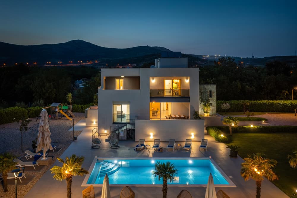 Split 21 illuminated pool at dusk with mountain backdrop, Split, Dalmatian Coast
