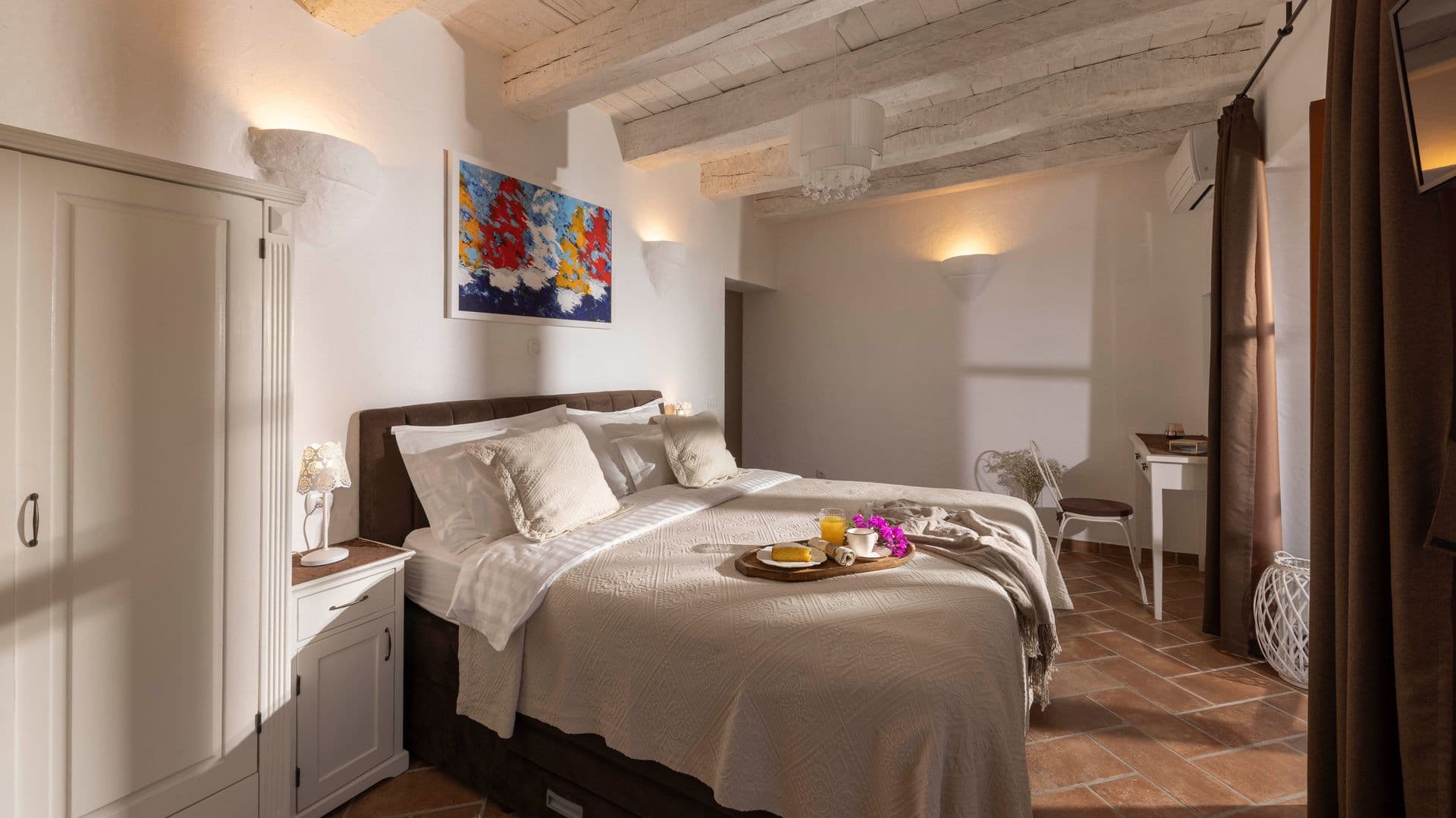 Beamed double bedroom with a dark timber bed at Aria to the Adriatic, Molunat, Croatia