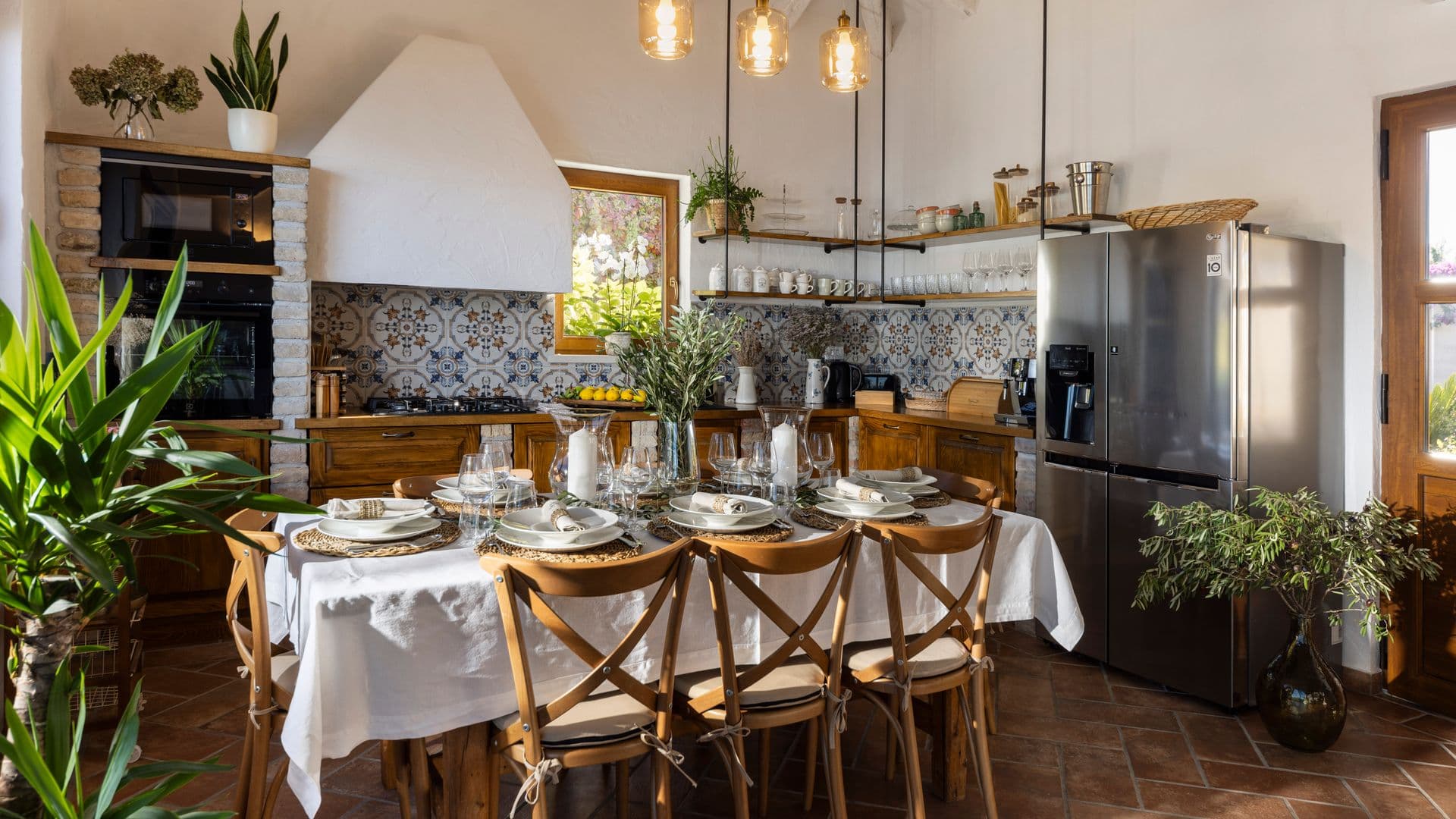 Rustic kitchen with tiled splashback and a laid dining table at Aria to the Adriatic, Croatia