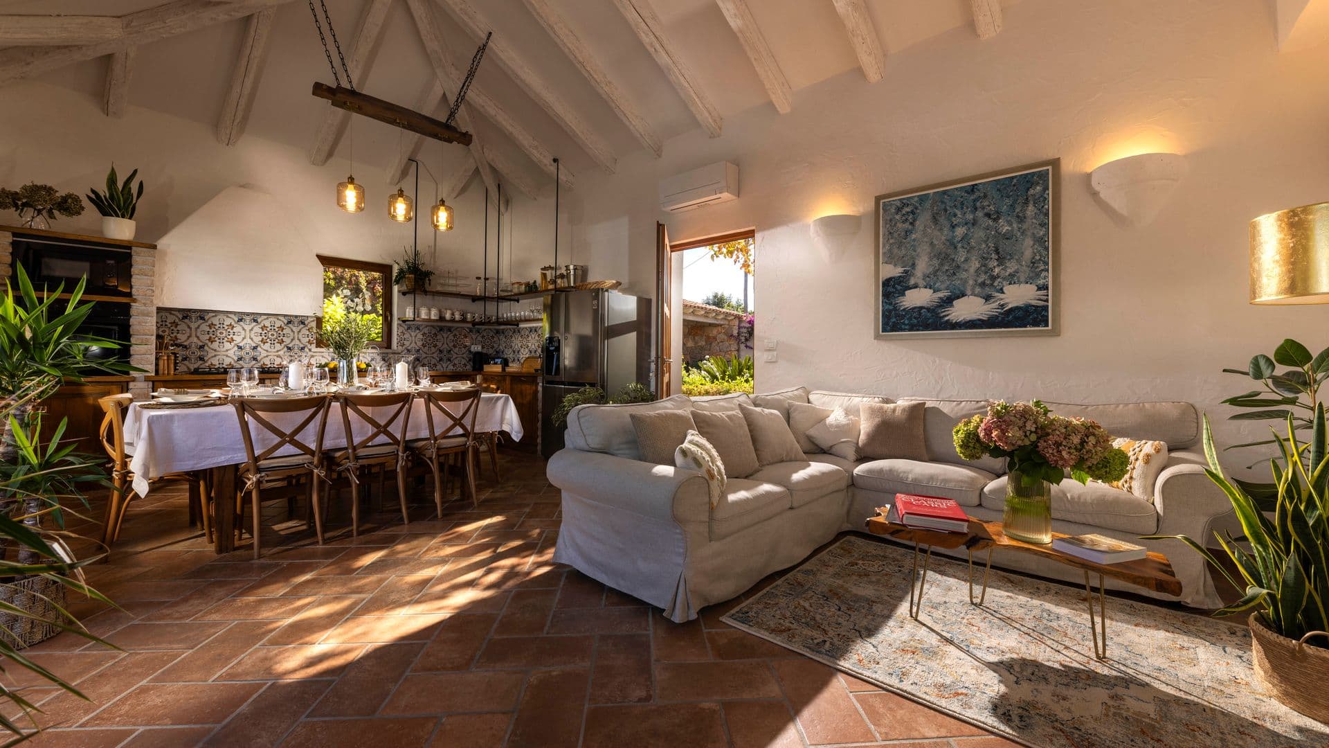 Beamed open-plan living and dining room with terracotta floors at Aria to the Adriatic, Croatia