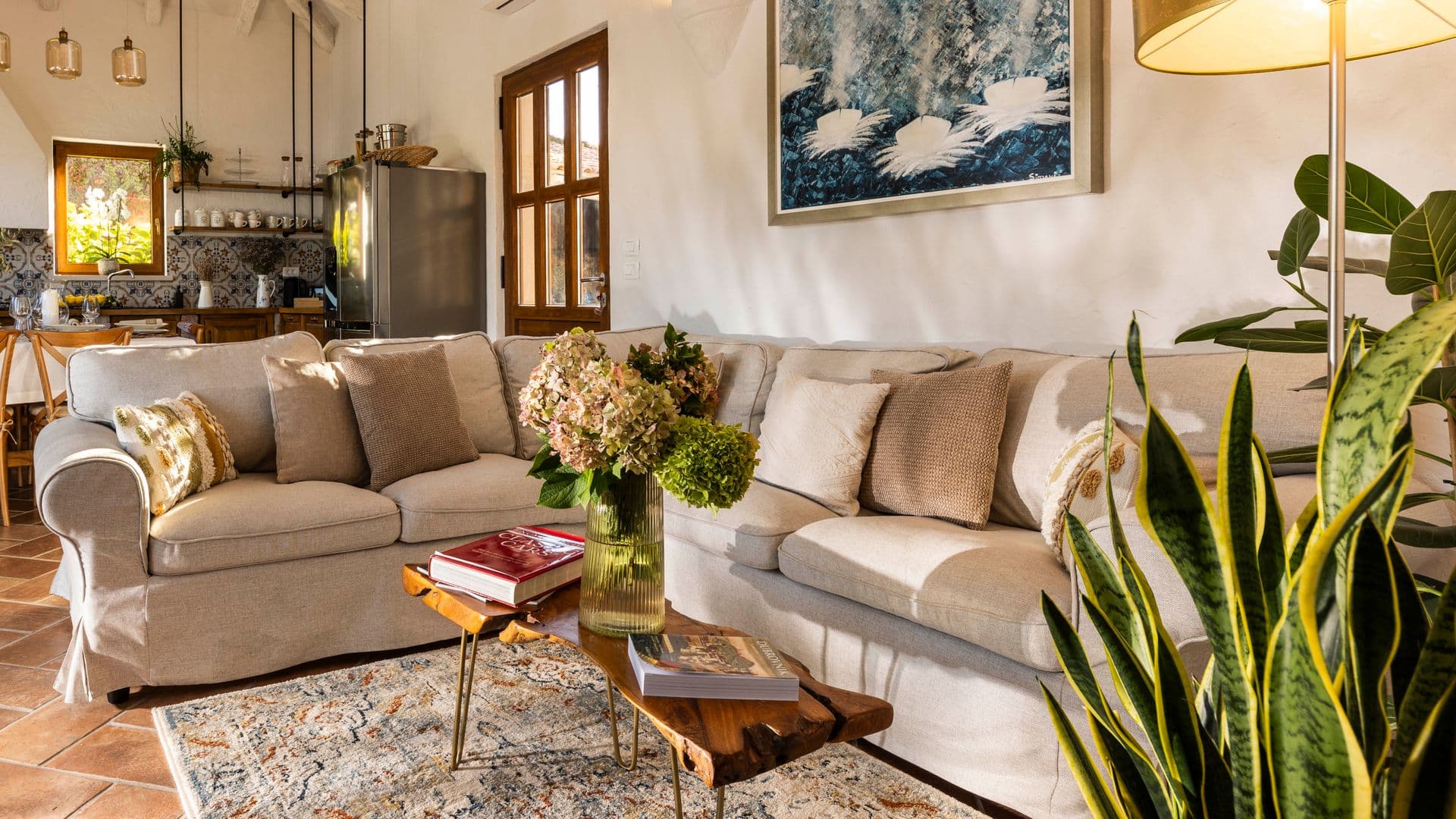 Living room with linen sofas, plants and folk artwork at Aria to the Adriatic, Molunat, Croatia