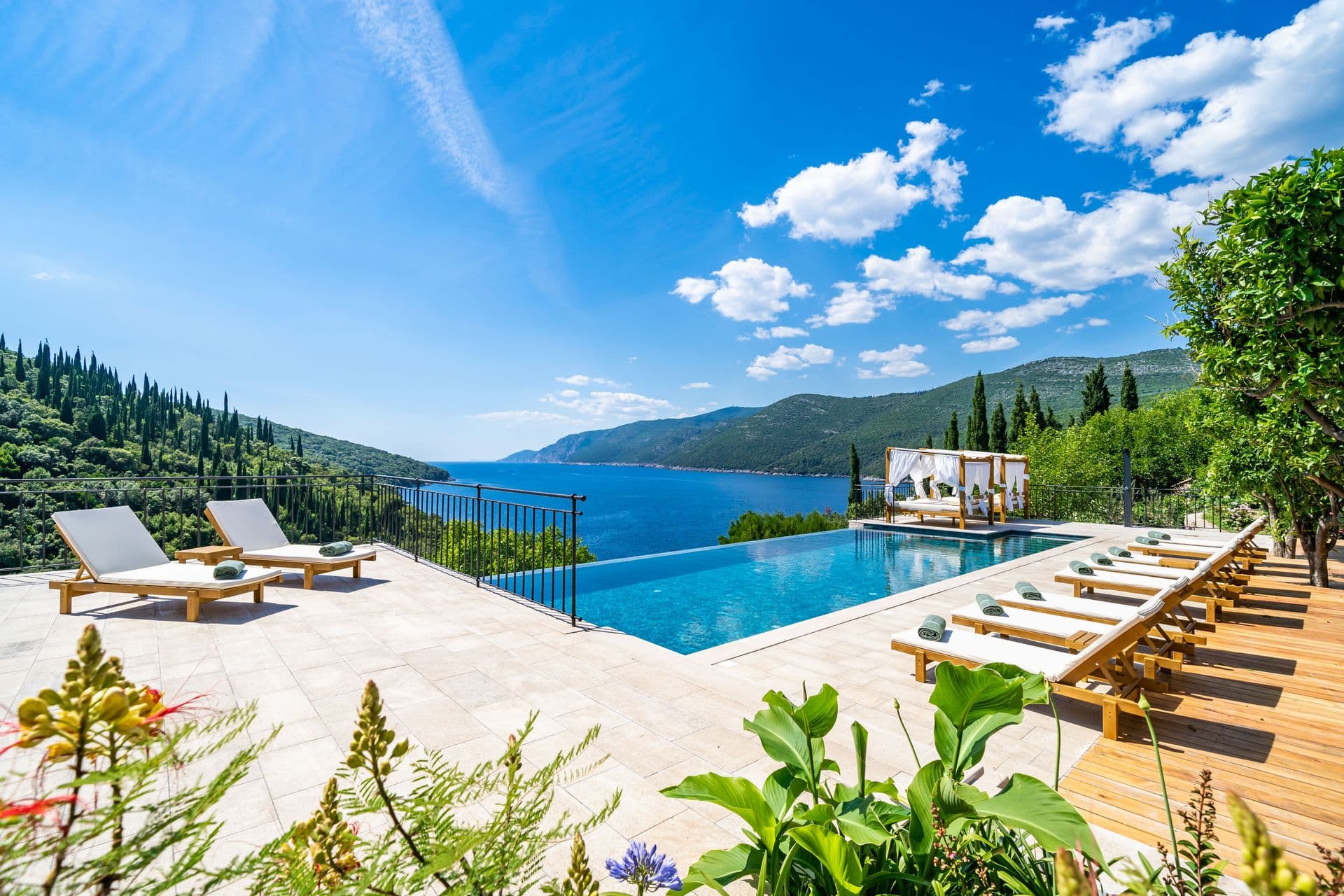 Infinity pool with sun loungers and a cabana overlooking the bay at Aria to the Adriatic, Molunat, Croatia