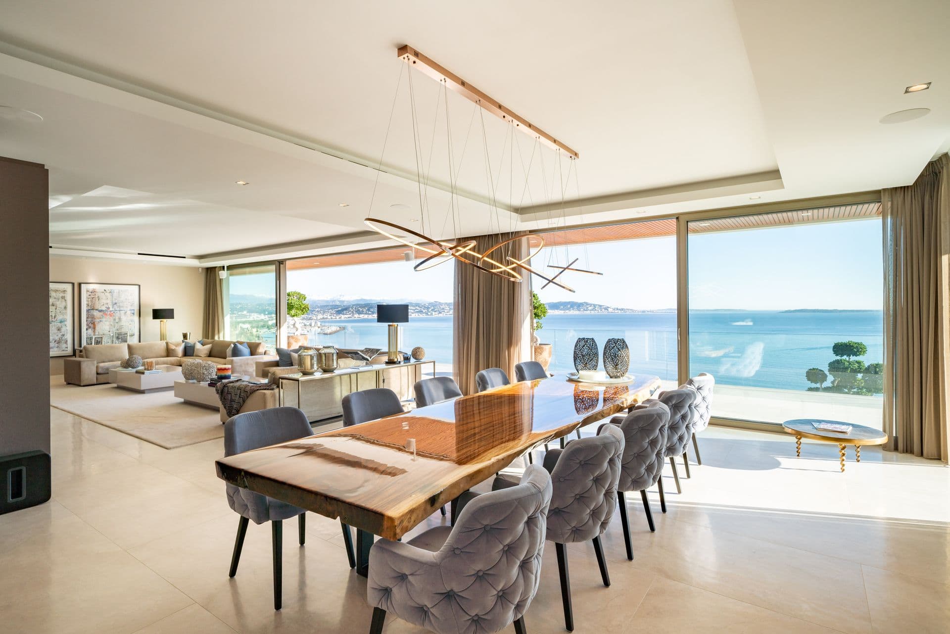 Dining table for eight with pendant lighting and sea views beyond