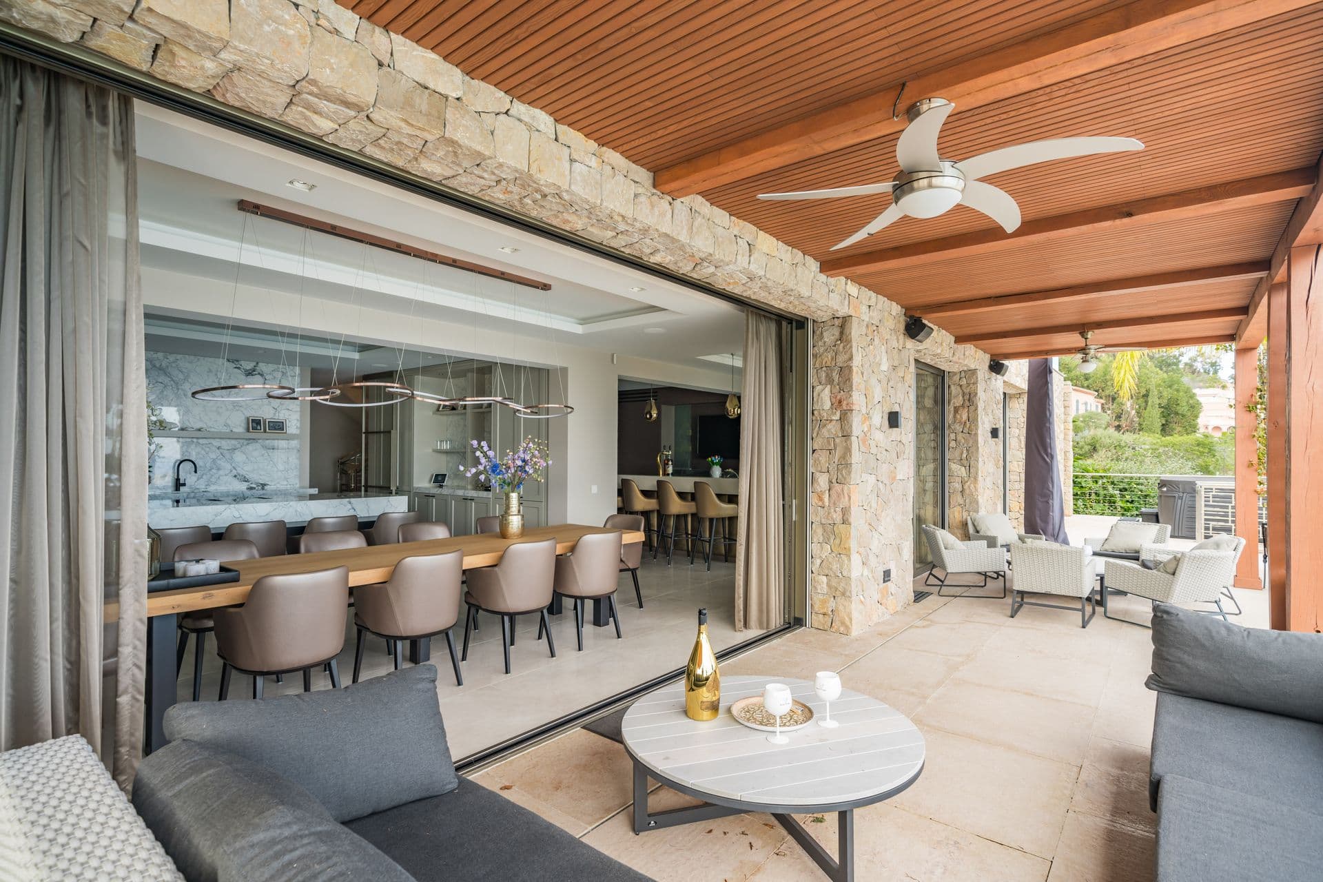 Open-plan kitchen with breakfast bar seating opening onto the terrace