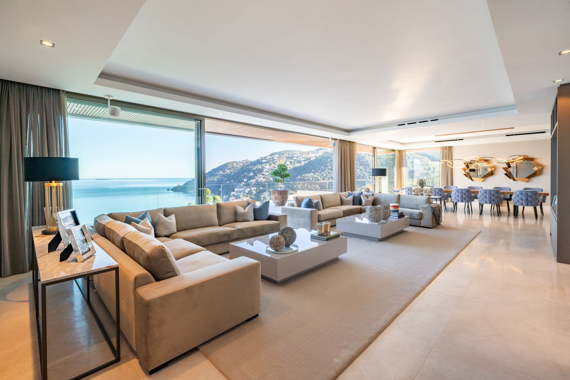 Open living and dining area with sea views through wide glass doors