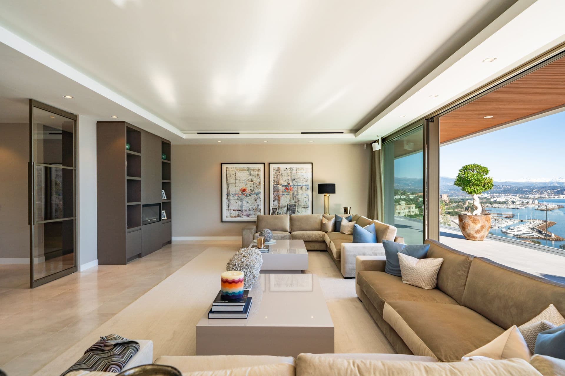 Living room with a corner sofa and sweeping views over the marina