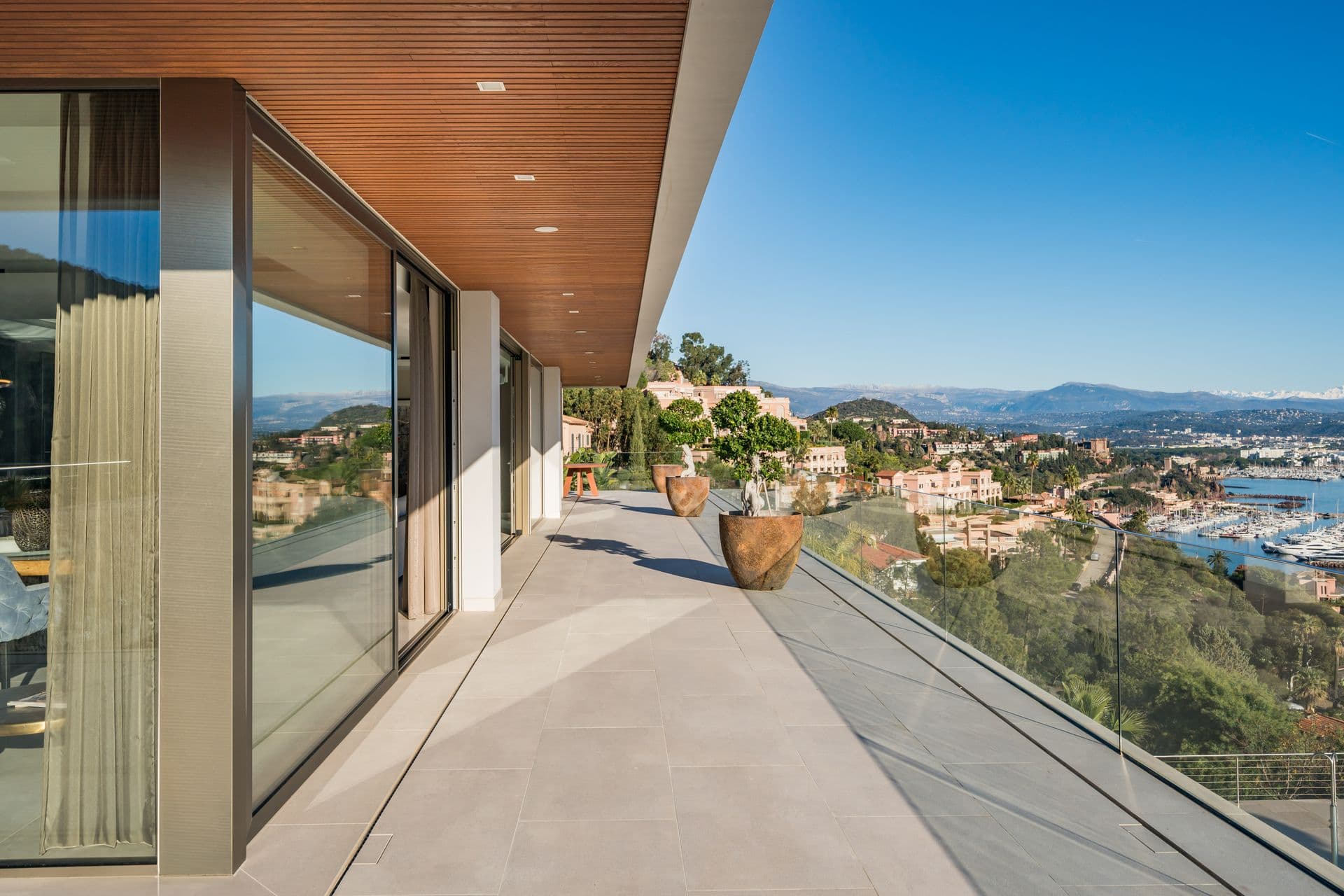 Covered walkway along the villa with uninterrupted sea and hillside views