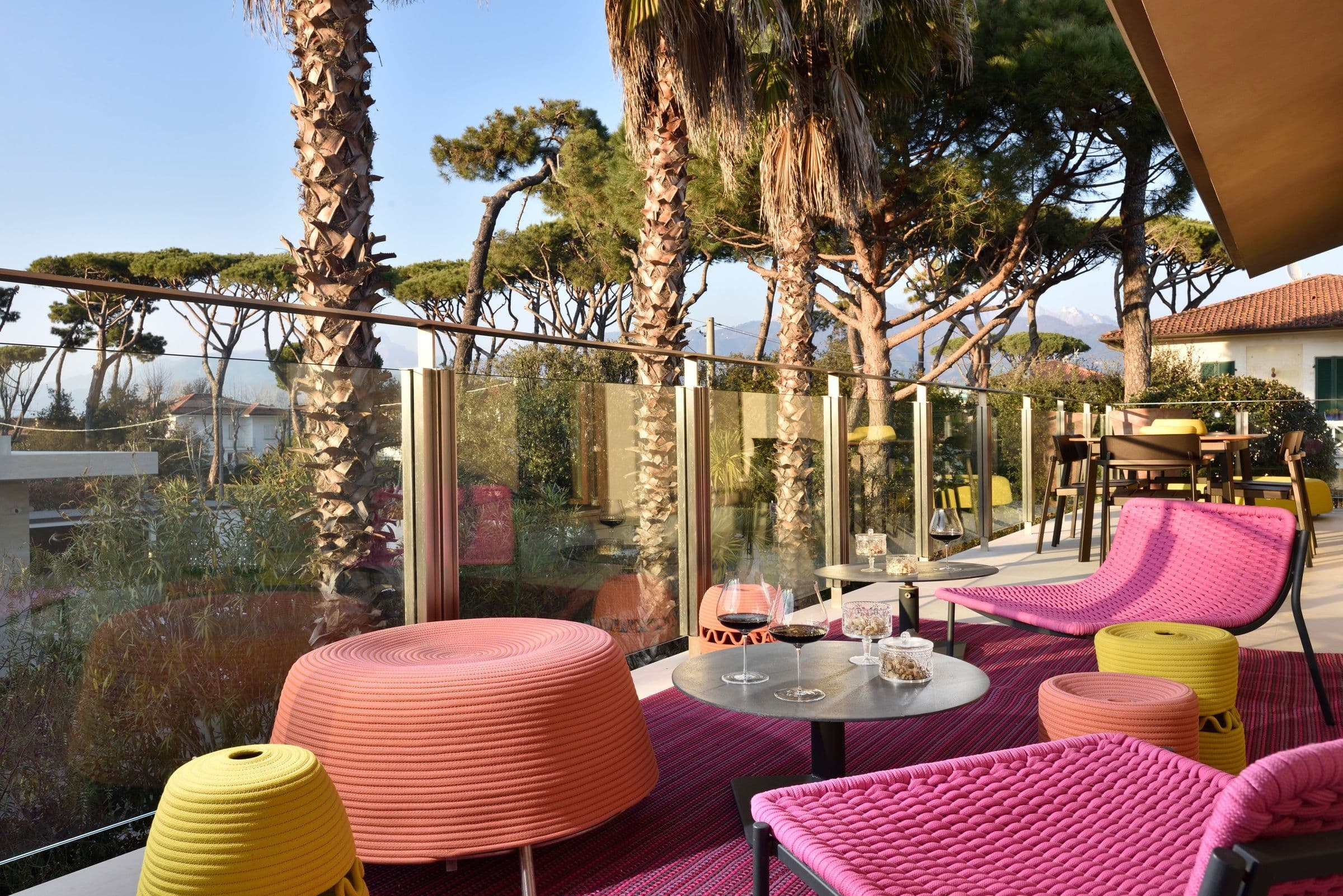 Villa Oblò upper terrace lounge with pink seating and sea views, Forte dei Marmi, Tuscany, Italy