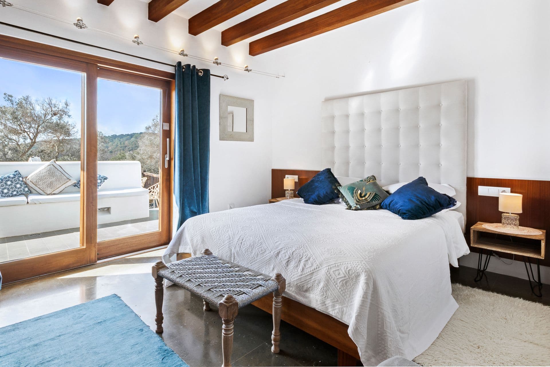 Bedroom with navy accents and terrace doors at Ode to Balearic Sunsets, Ibiza