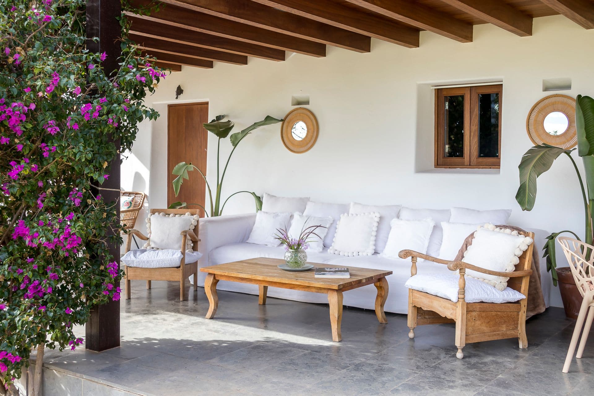 Covered outdoor lounge with bougainvillea at Ode to Balearic Sunsets, Ibiza