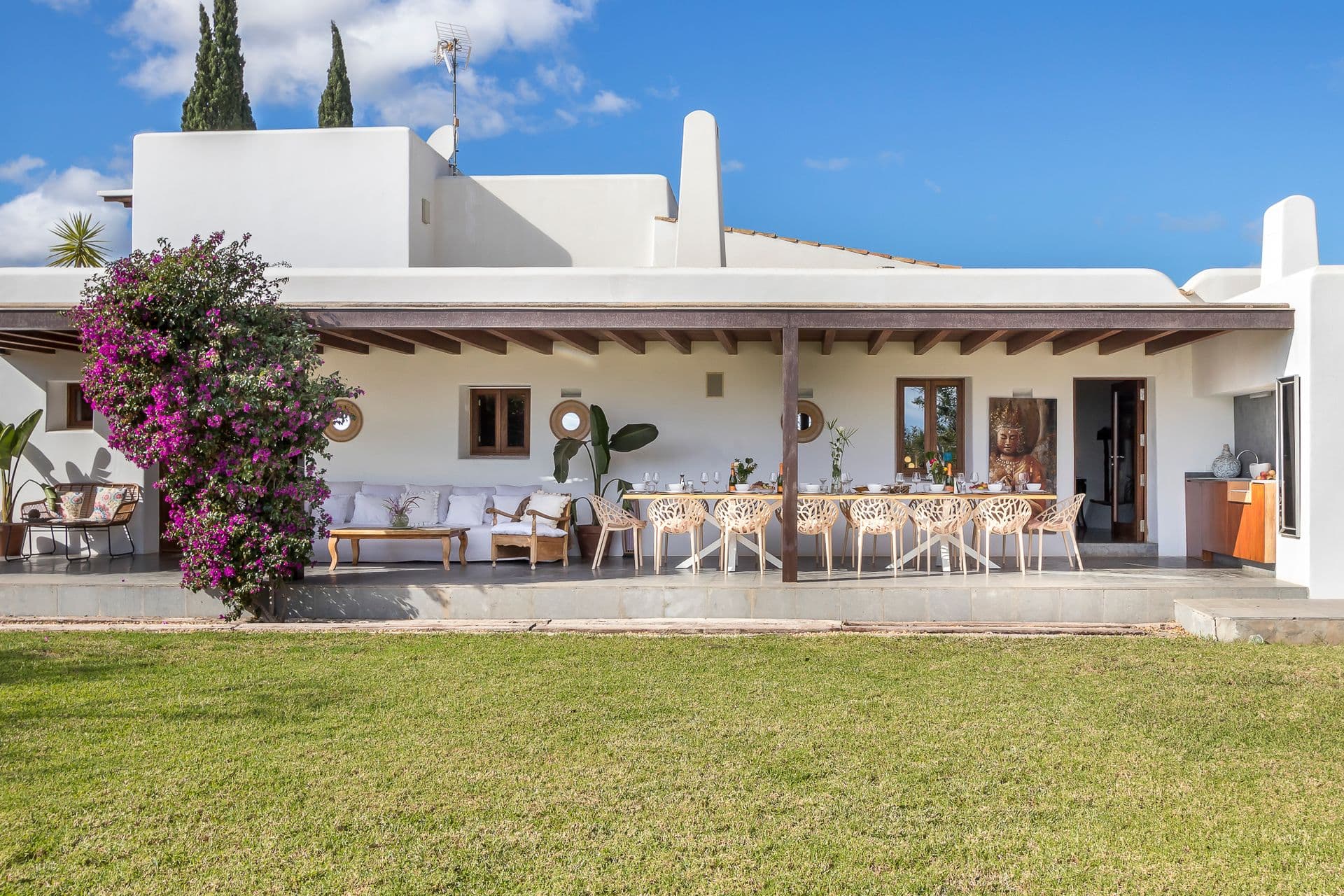 Whitewashed finca exterior and lawned grounds at Ode to Balearic Sunsets, Ibiza