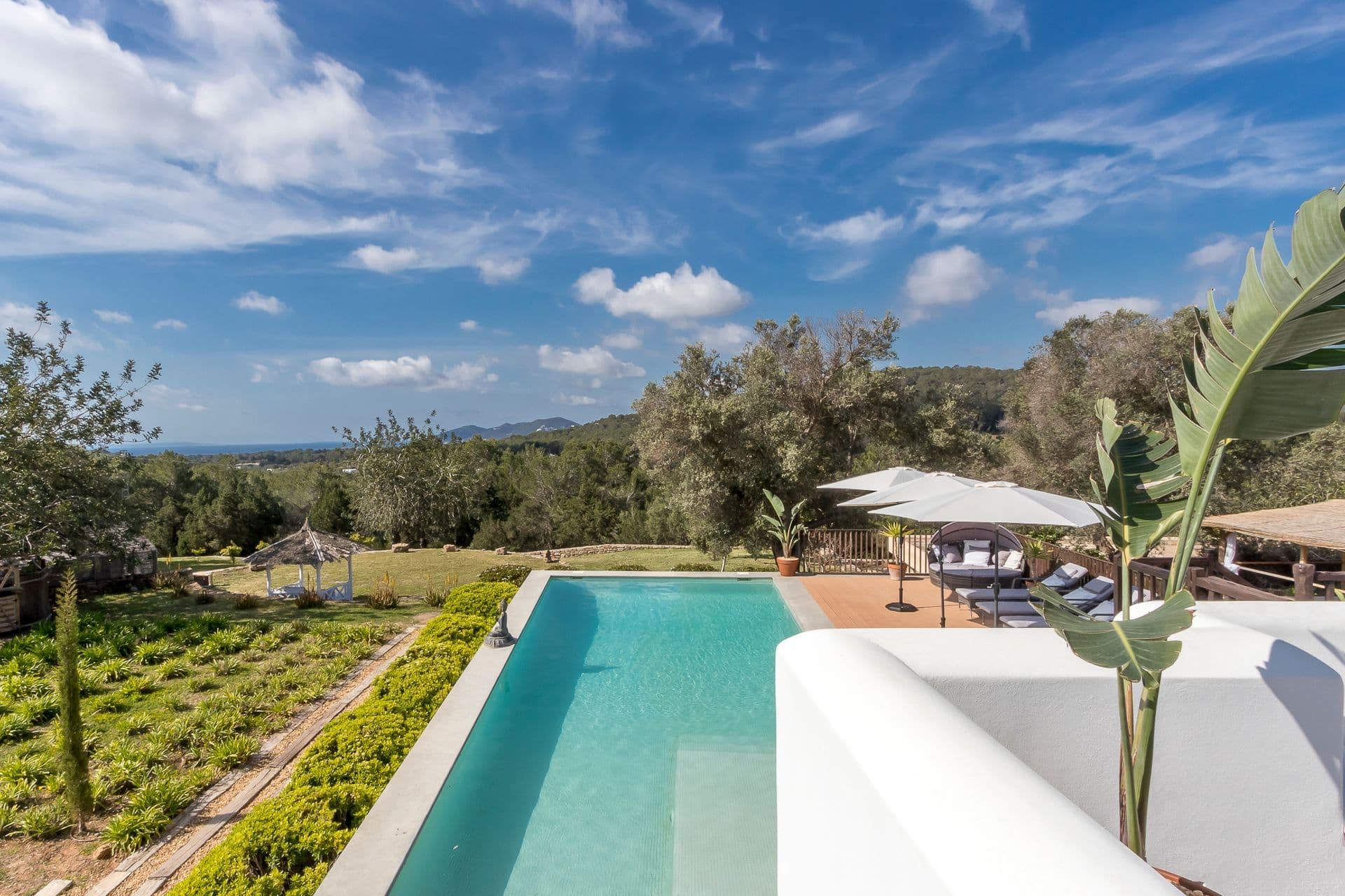 Long lap pool framed by landscaped gardens at Ode to Balearic Sunsets, Ibiza