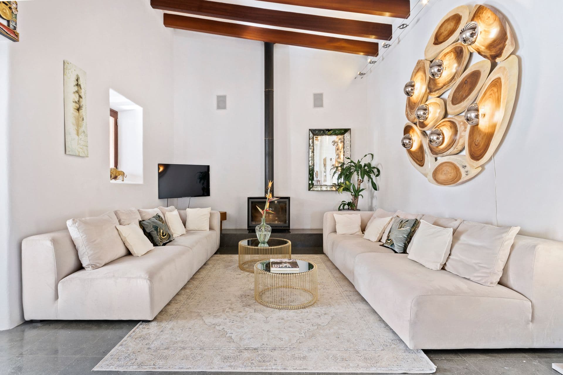 Beamed-ceiling living room with white sofas at Ode to Balearic Sunsets, Ibiza