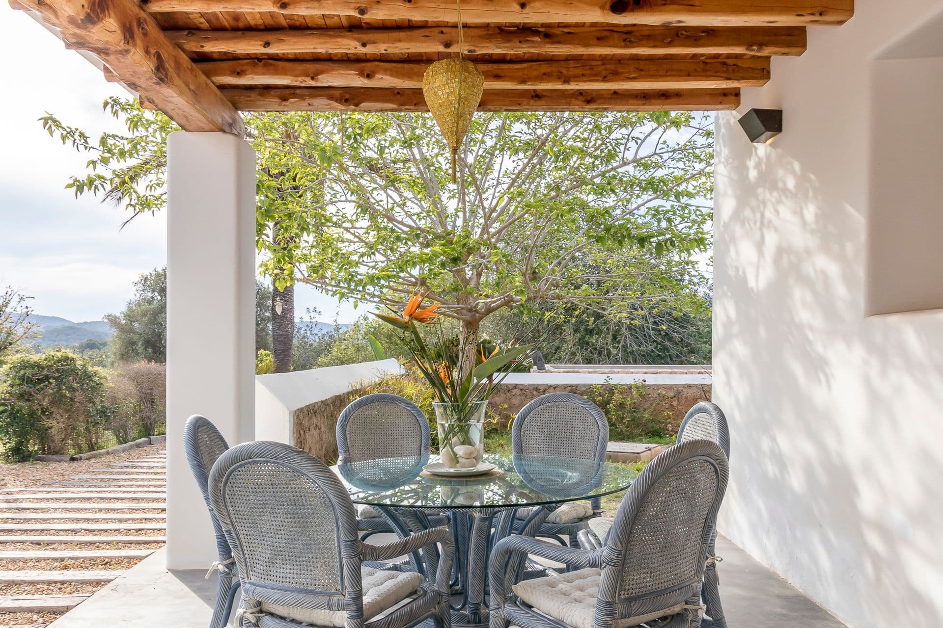 Round outdoor dining table with countryside views at Ode to Balearic Sunsets, Ibiza