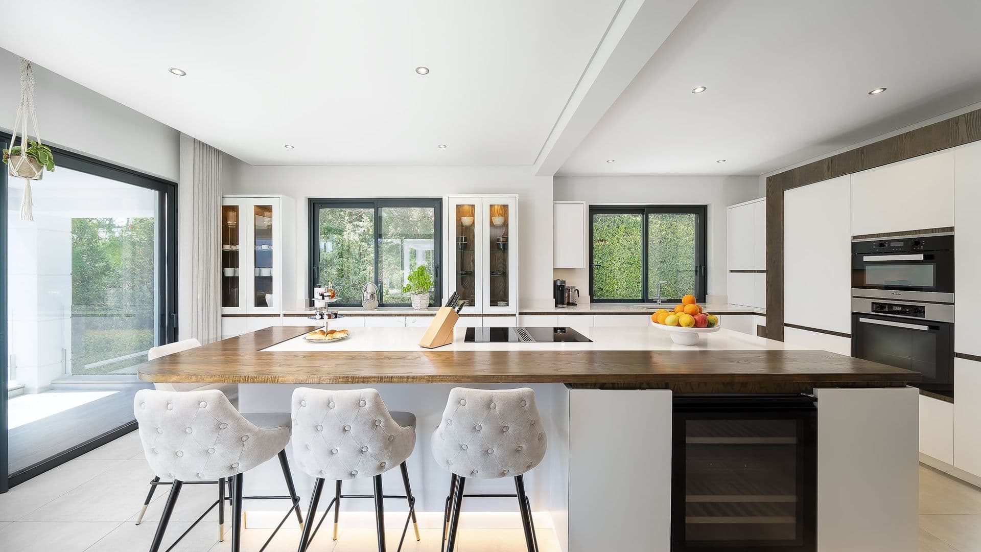 Kitchen island with wood countertop and upholstered bar stools