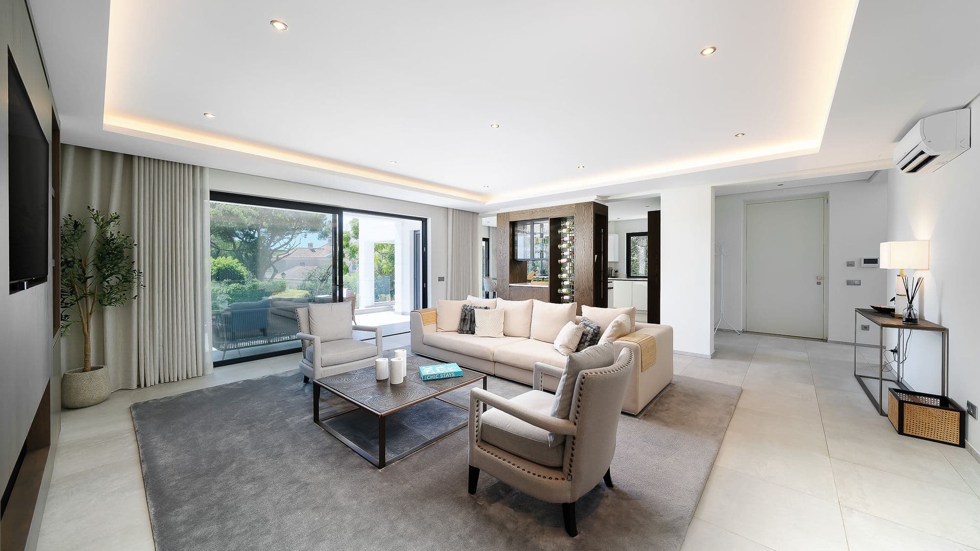 Bright living room in neutral tones with sliding doors onto the garden