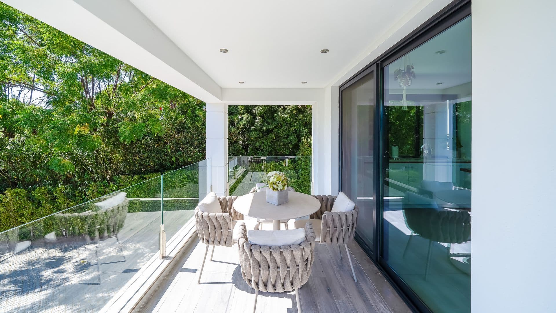 Covered terrace corner with dining seating opening onto the garden