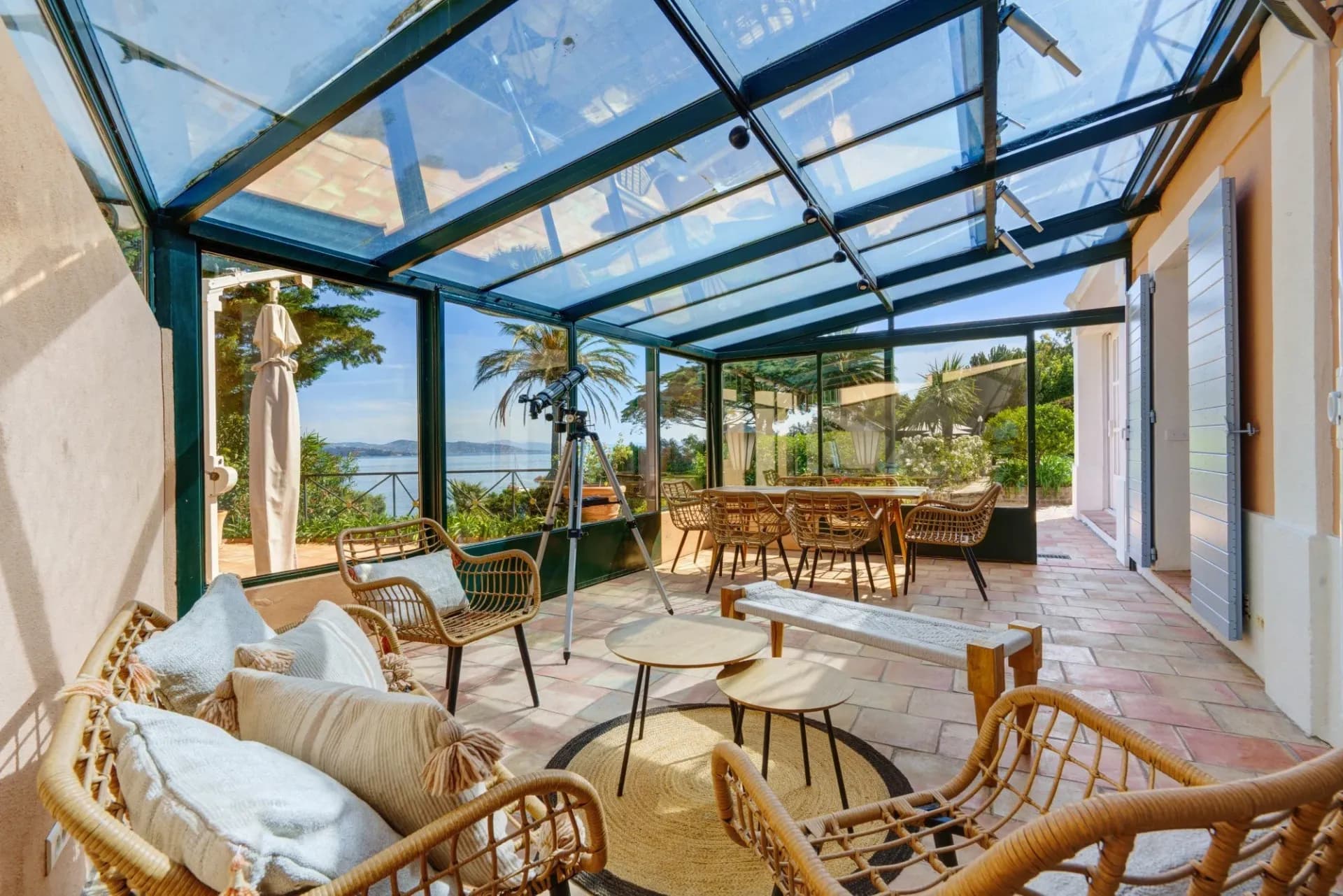 Glass-roofed conservatory lounge with rattan seating at South Sea Bliss