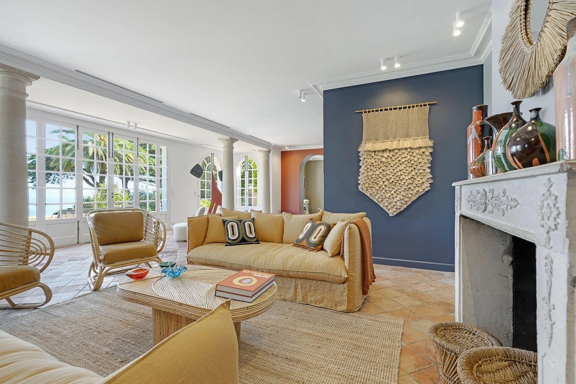 Living room with a navy accent wall and macrame wall hanging at South Sea Bliss