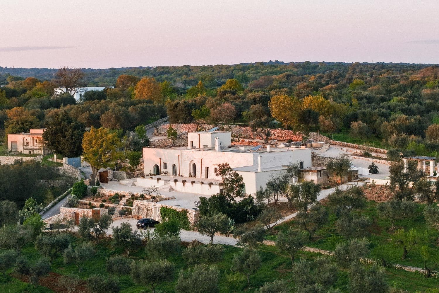 Villa Lucantu aerial exterior view with stone architecture and olive groves, Cisternino, Puglia, Italy