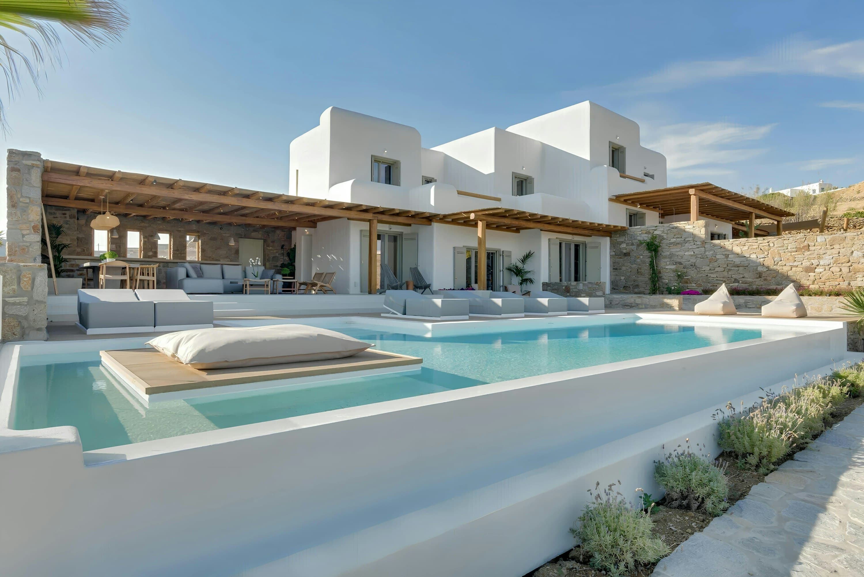 Seashore Silhouette villa exterior with infinity pool and Cycladic architecture, Mykonos, Greece