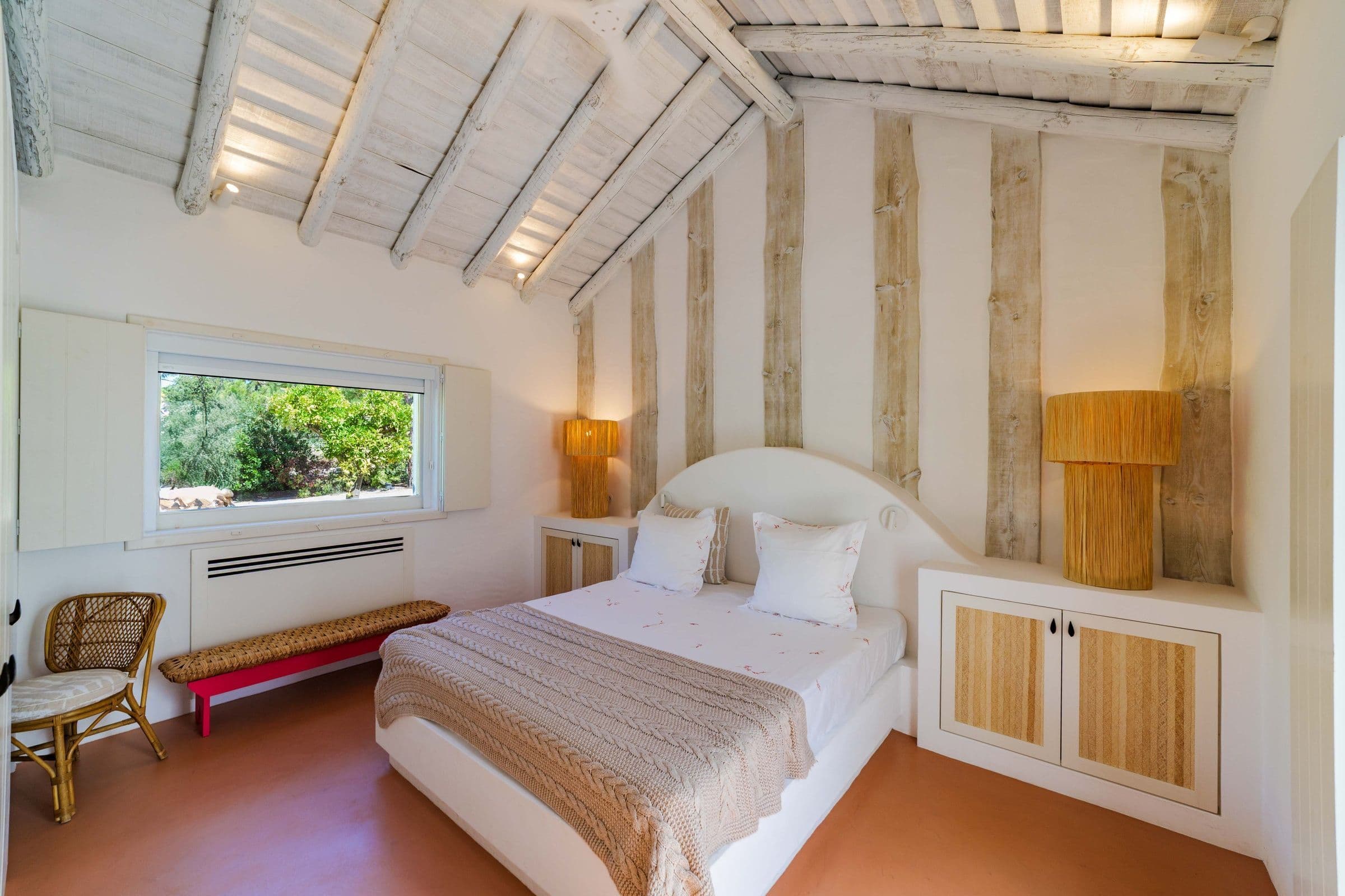 Villa Harmonia da Comporta master bedroom with paneled headboard and sun mirror, Comporta, Portugal