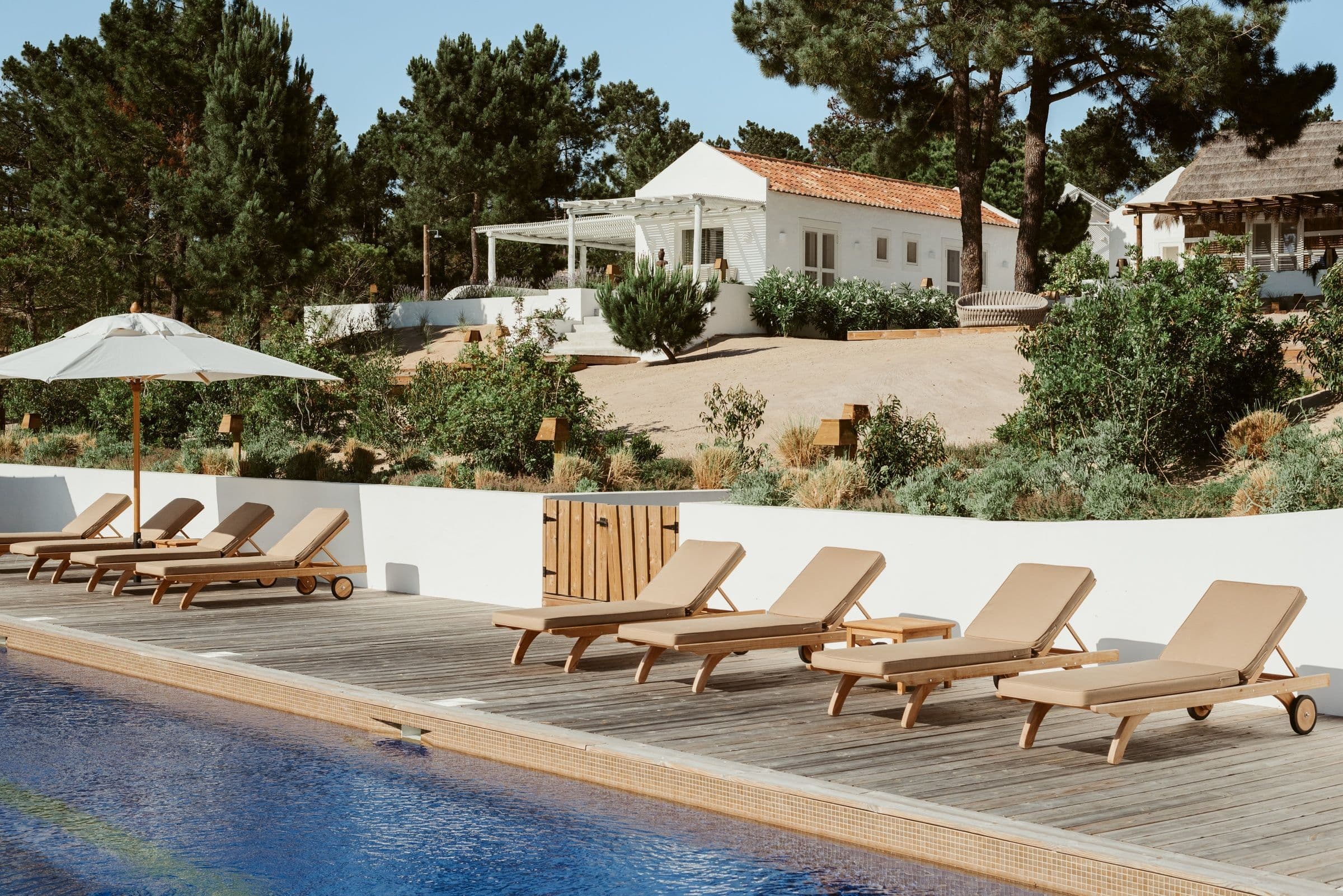 Villa Harmonia da Comporta pool deck with sun loungers and gardens, Comporta, Portugal