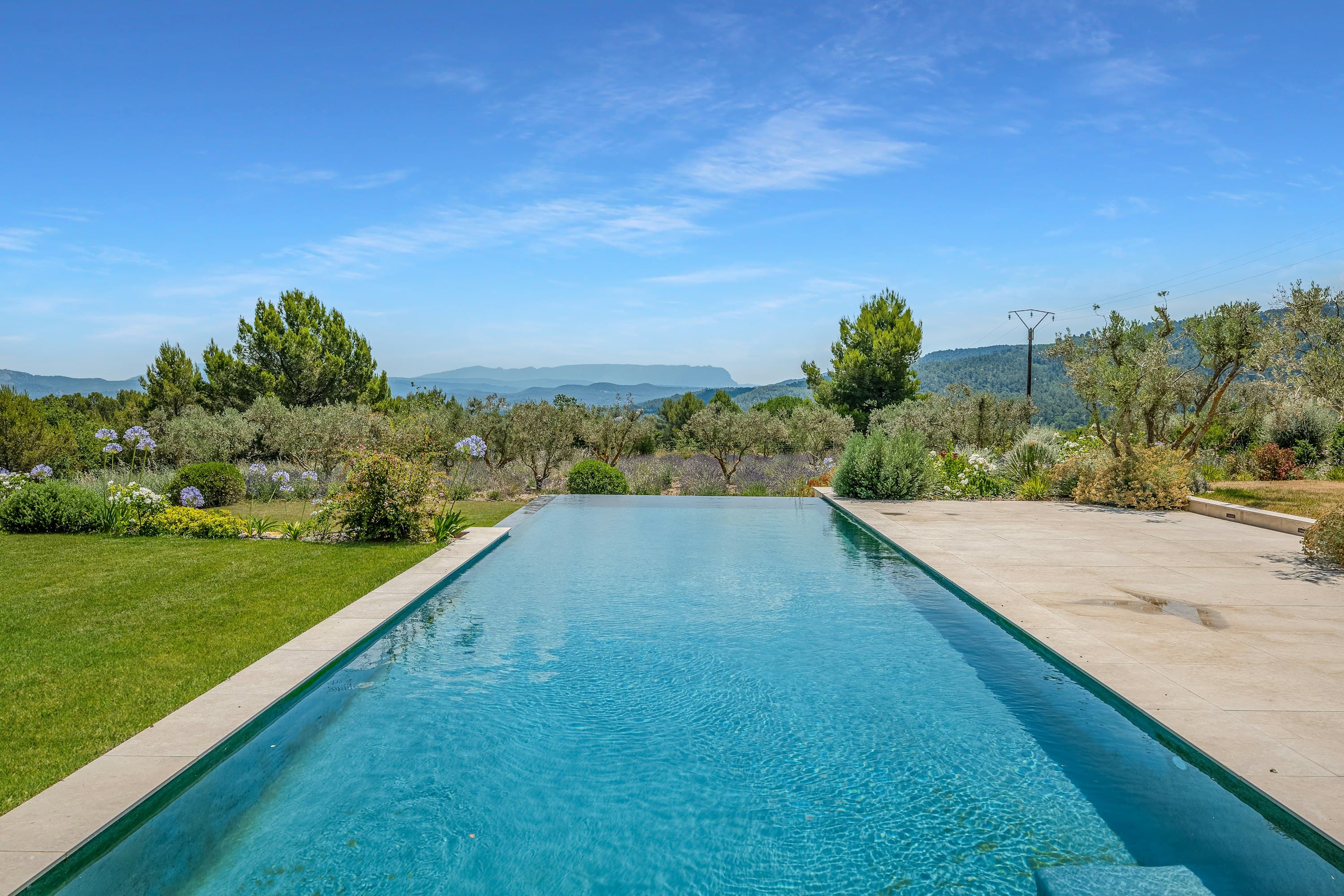 Alpilles Retreat infinity pool with mountain views and olive groves, Aix-en-Provence, France
