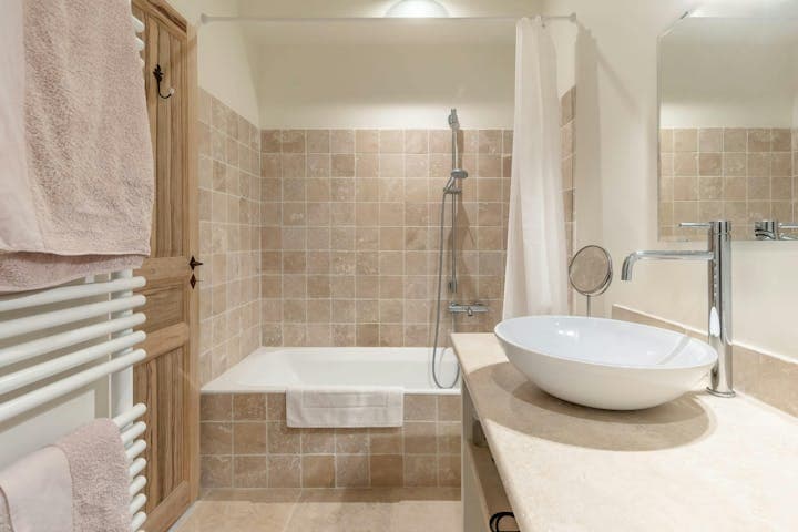 Little Luberon guest bathroom with terracotta tiles and travertine vanity, Ménerbes, Provence, France