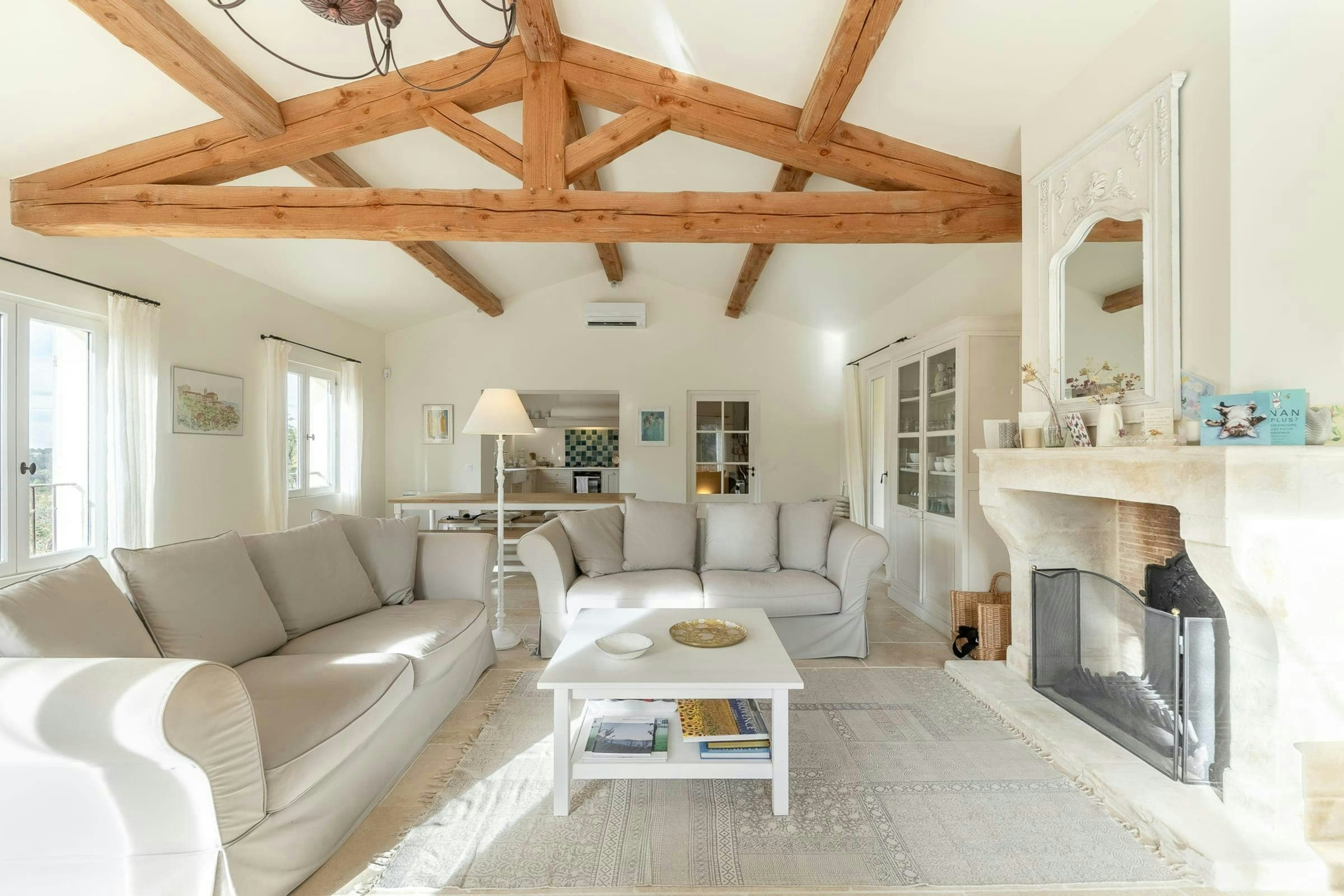 Little Luberon living room with exposed beams and stone fireplace, Ménerbes, Provence, France