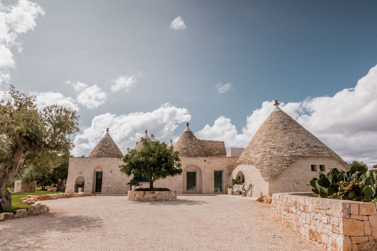 Trullo Barbagianni luxury villa exterior with conical trulli roofs, Cisternino, Puglia, Italy