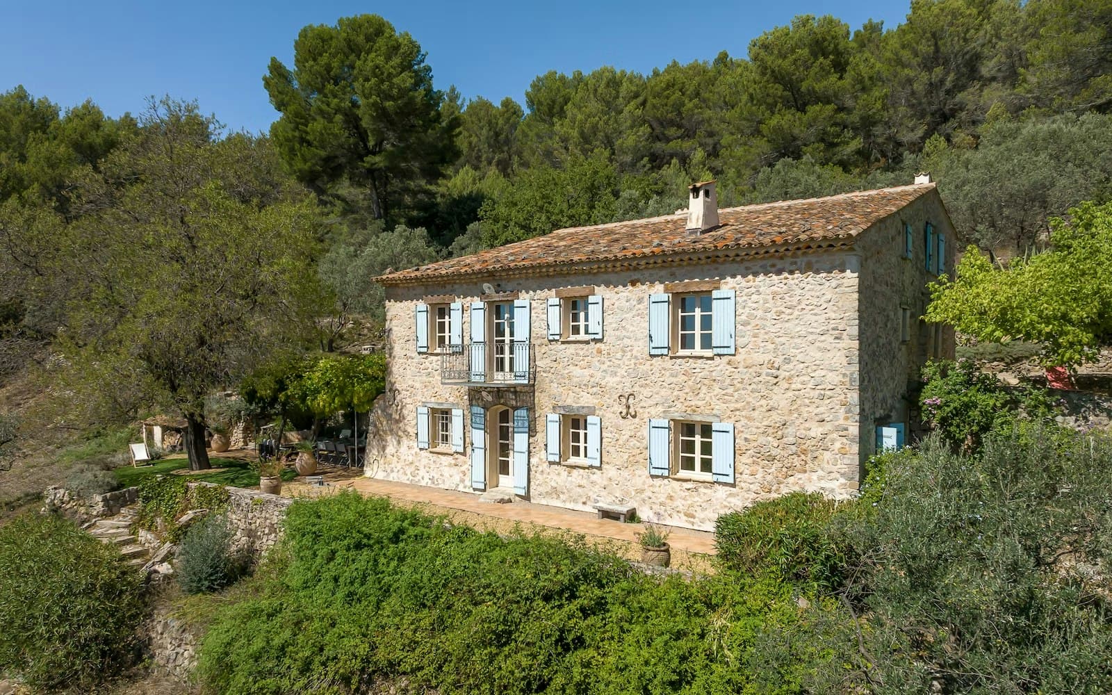 Choral Words villa exterior with stone facade and blue shutters, Var, Provence, France