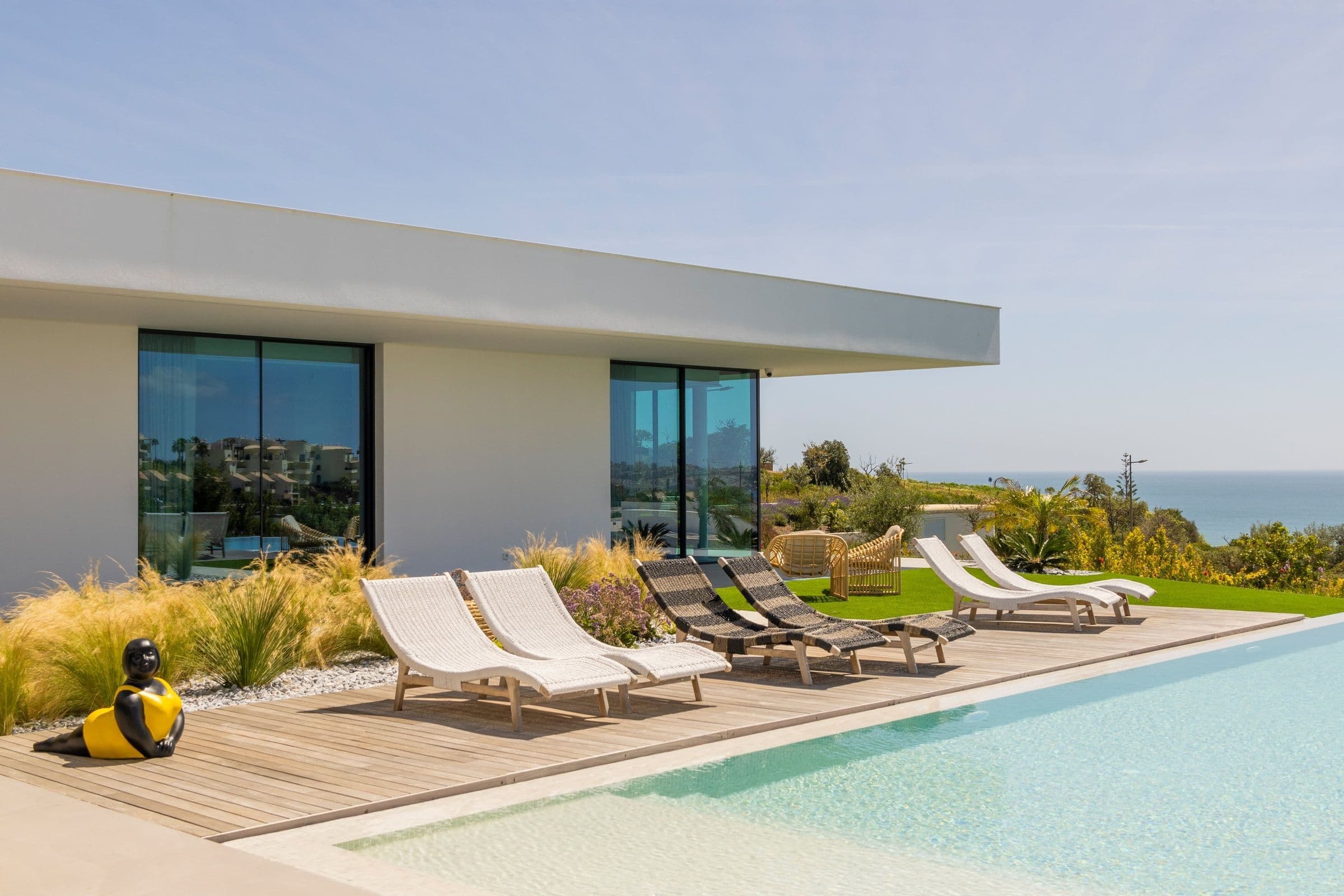 Casa Monroe infinity pool with wooden deck and ocean views, Algarve, Portugal
