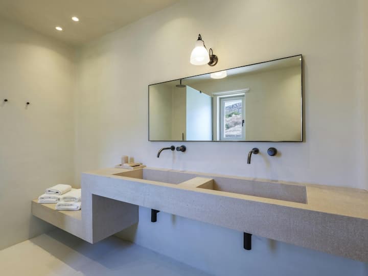 The Moon Muse master bathroom with concrete vanity, Agios Ioannis, Cyclades Islands, Greece
