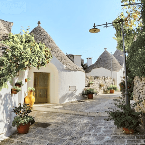 Itria Birdsong trullo architectural detail showing cone-shaped roofs, Martina Franca, Puglia, Italy